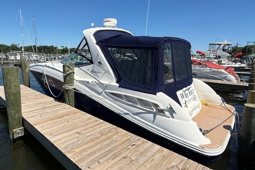 2008 Sea Ray Sundancer 330 docked at a marina under clear blue skies.