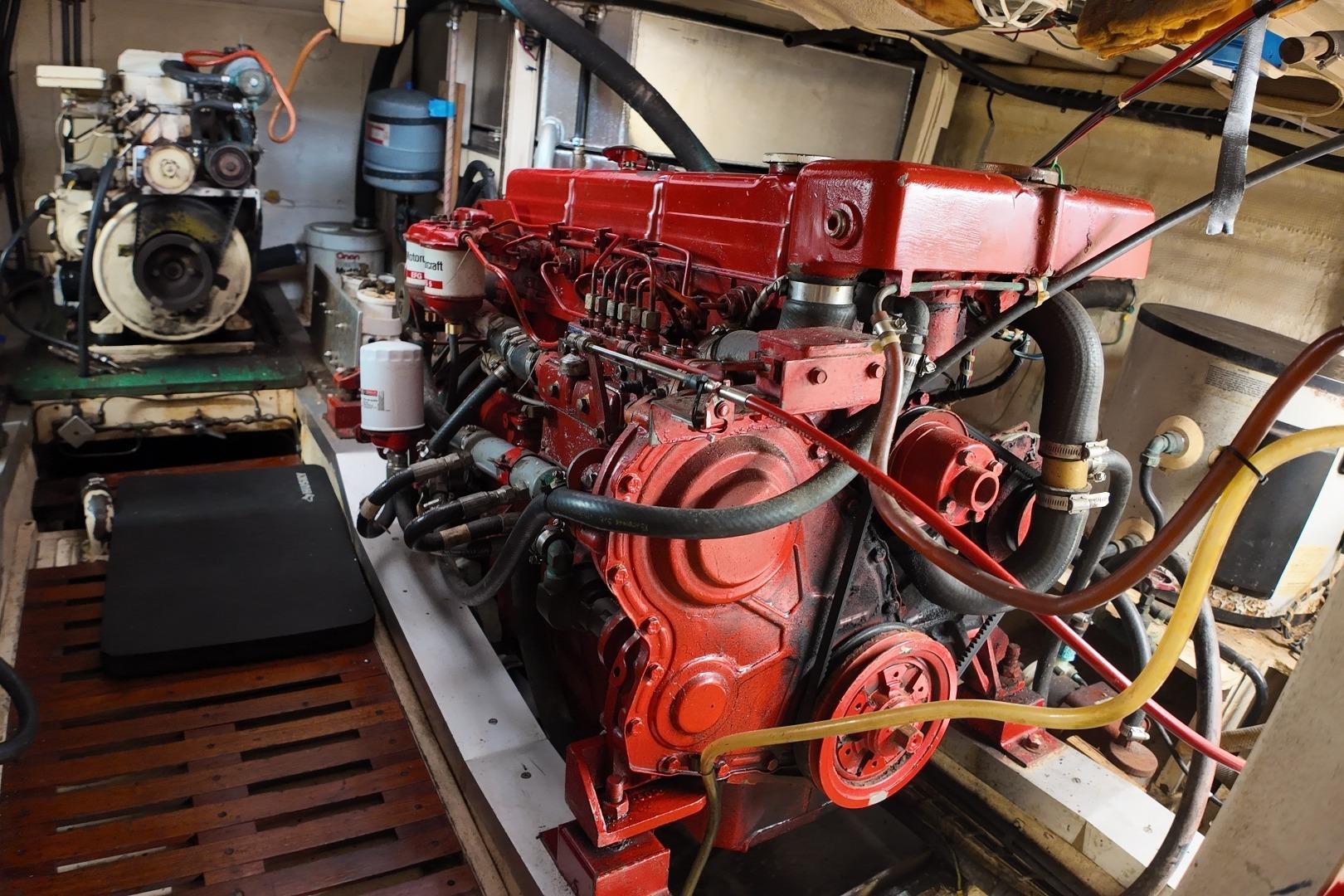 Engine room of a 1978 Grand Banks 42 Classic yacht, featuring a red diesel engine.