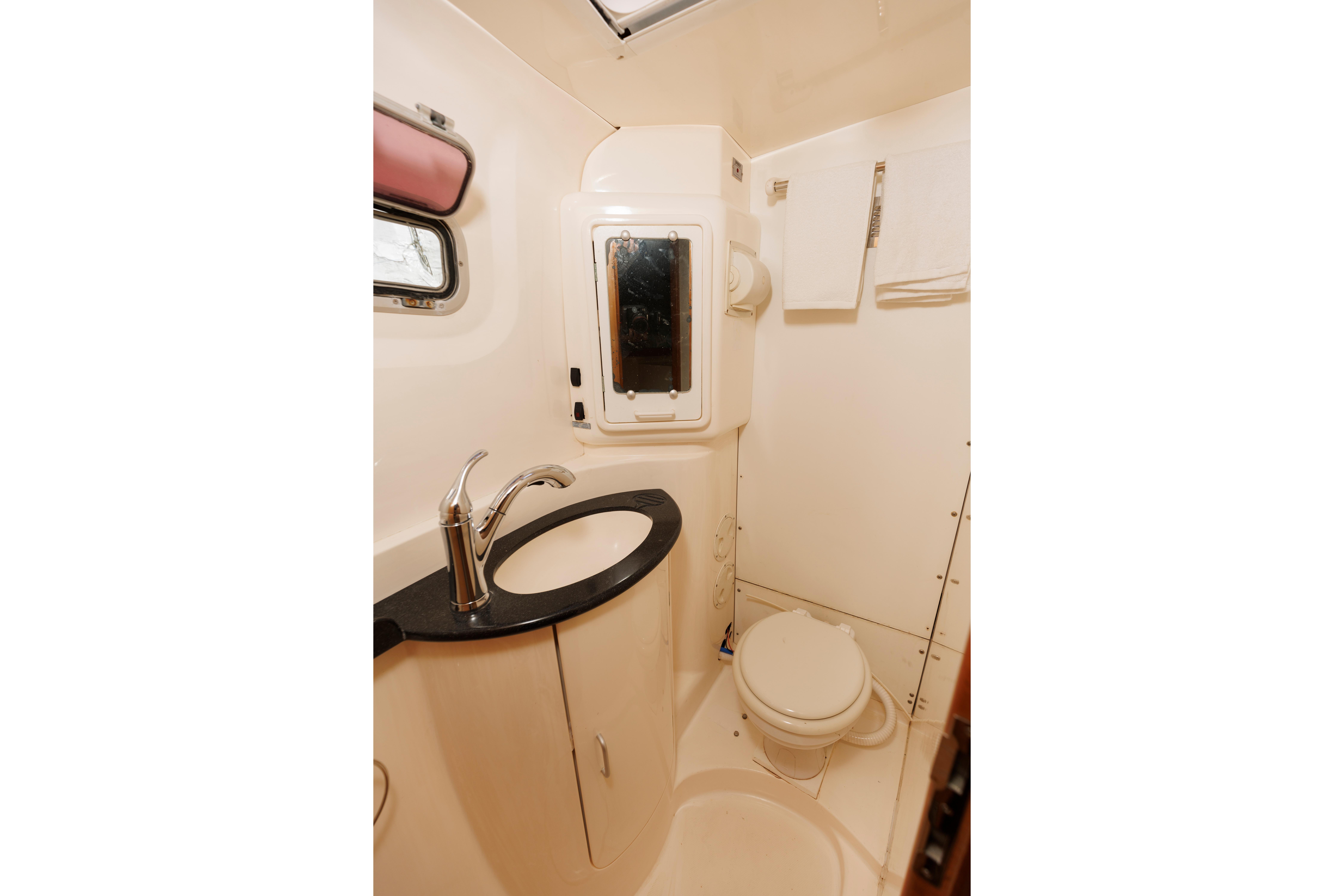 Bathroom interior of a 2006 Leopard 43 yacht with sink and toilet.