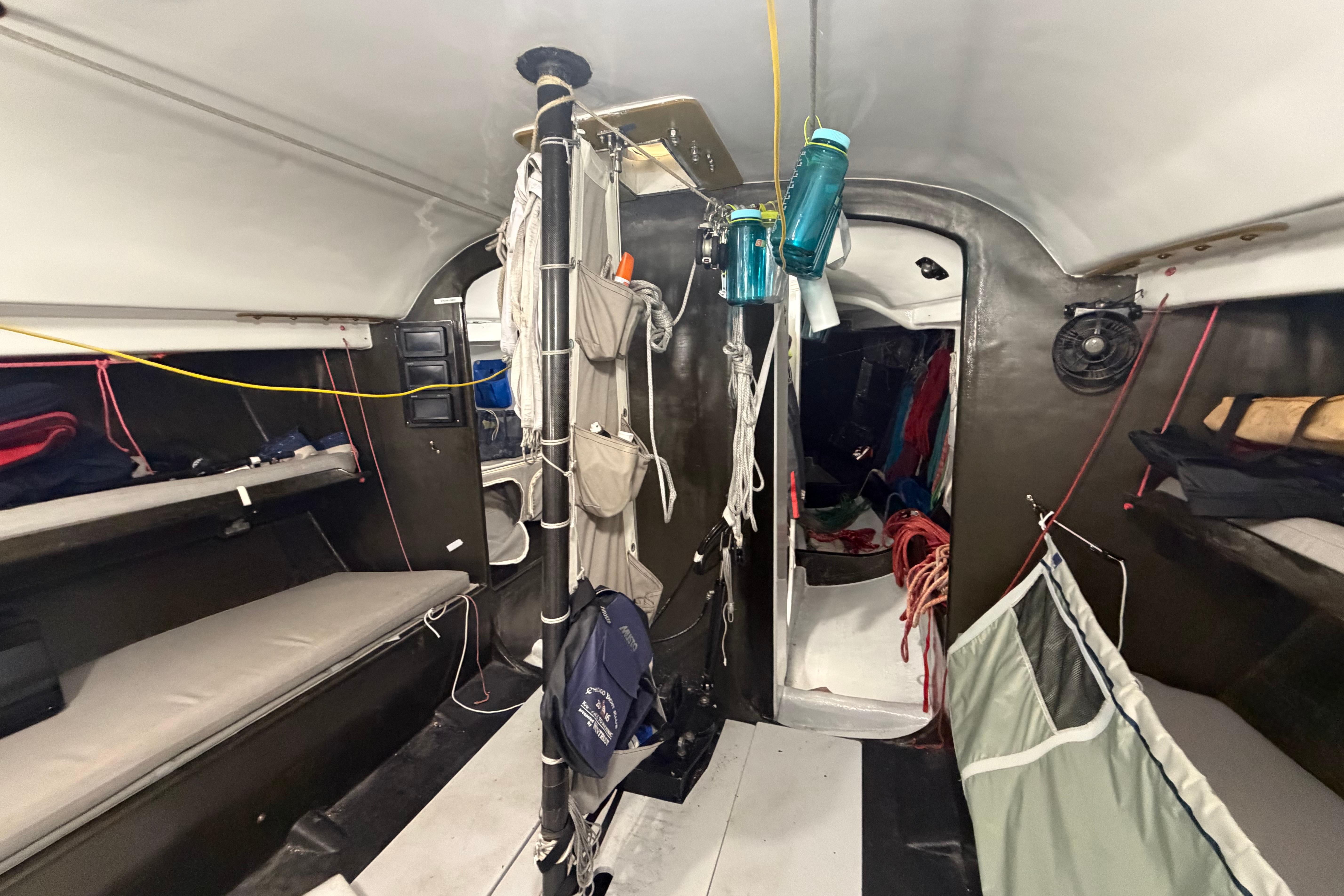 Interior of Andrews 63 sailboat with bunks, storage, and nautical equipment.