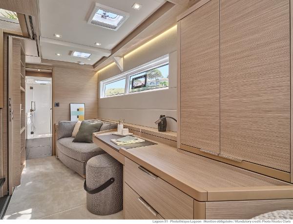 Luxurious interior of 2025 Lagoon 51 ICONIC yacht with modern furnishings and natural light.