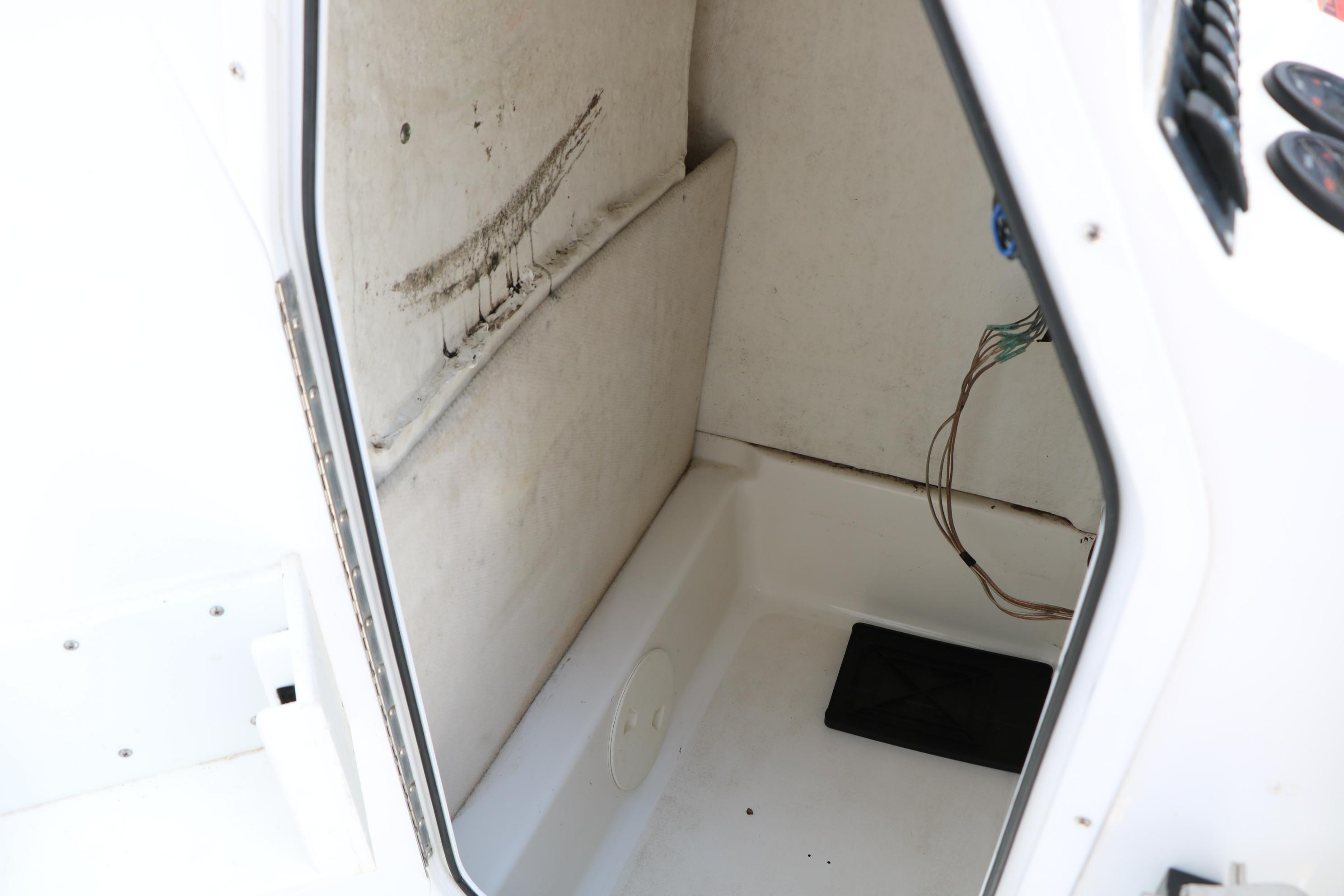 Interior view of a 2015 Sea Hunt BX 22 BR boat compartment with exposed wiring.