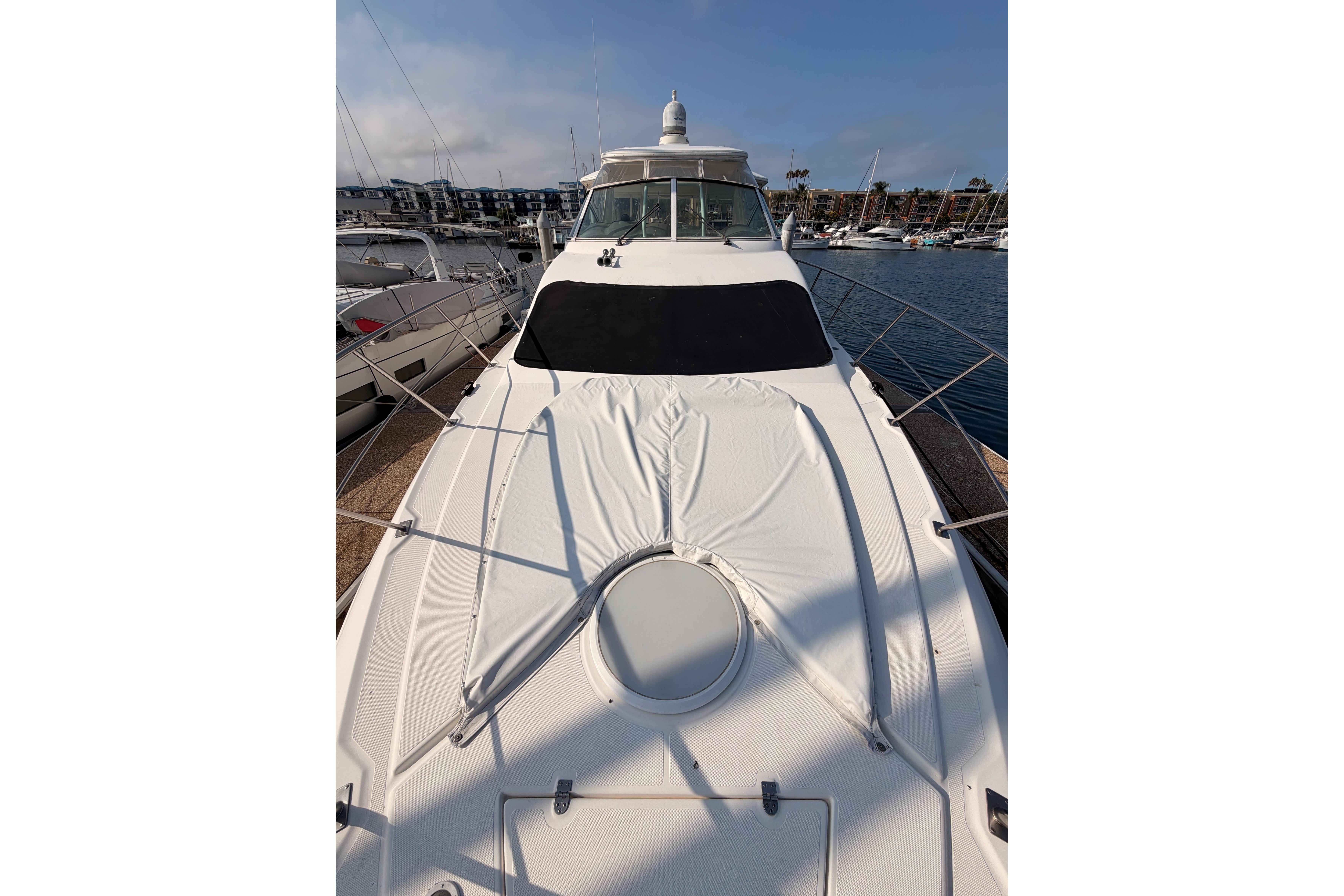 2005 Cruisers Yachts 405 Express Motoryacht docked at marina, showcasing sleek design.