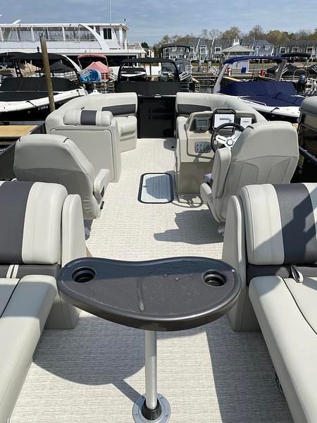 The image shows the interior of a 2020 Xcursion 243 RFX boat with gray seating.