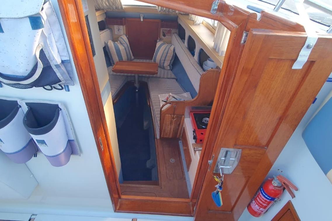 Interior view of 1989 Fairey Spearfish MKIII boat, featuring wooden cabin and seating area.