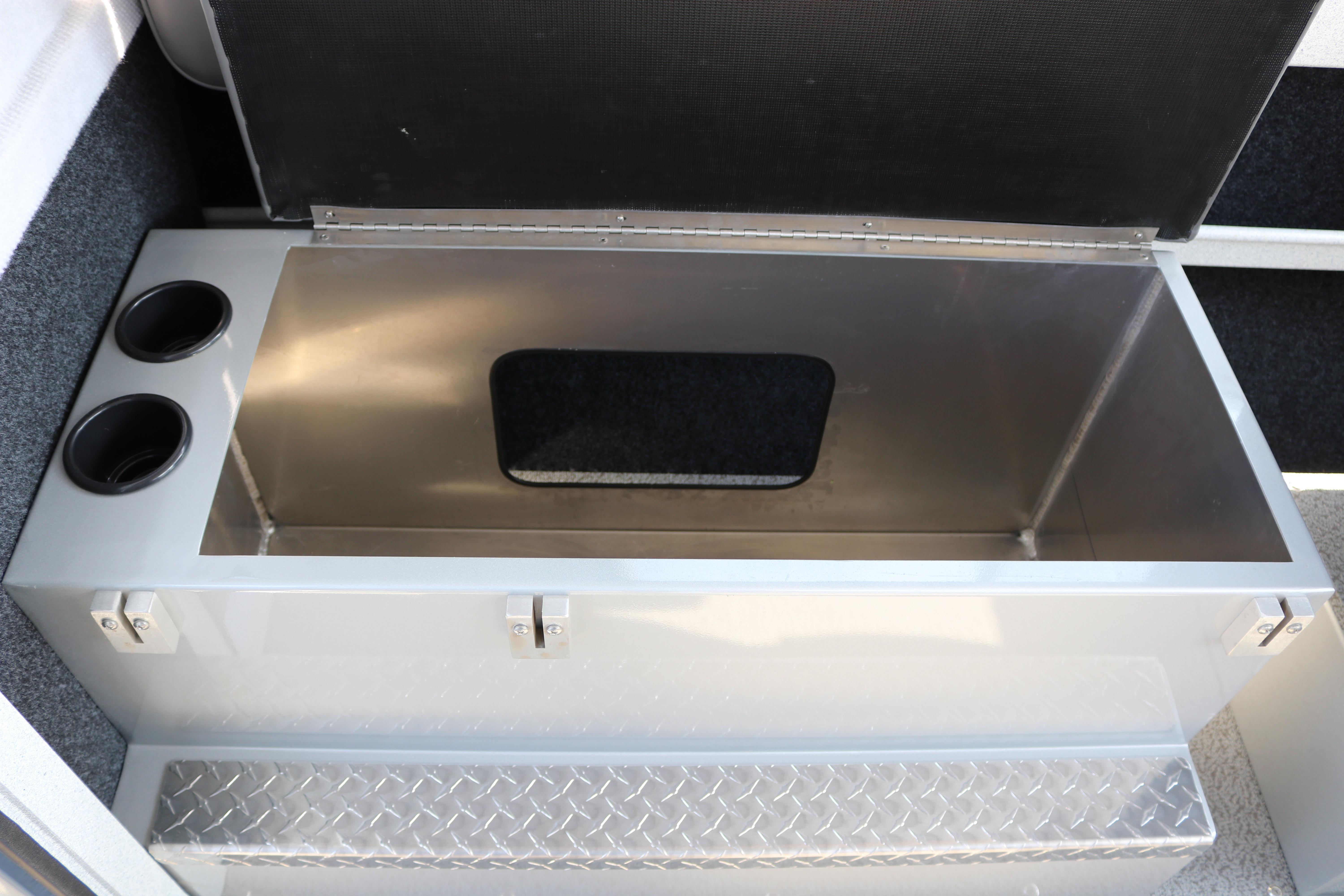 Open storage compartment in 2026 KingFisher 2425 Escape HT boat with cup holders.
