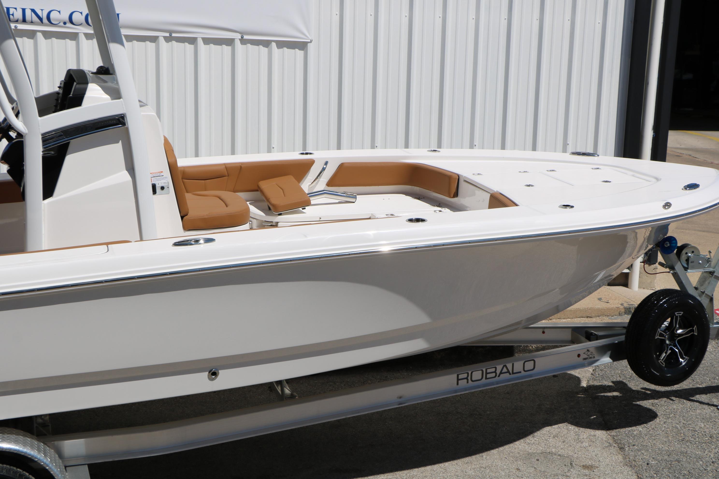 2026 Robalo 246 Cayman boat on trailer, featuring sleek design and tan seating.