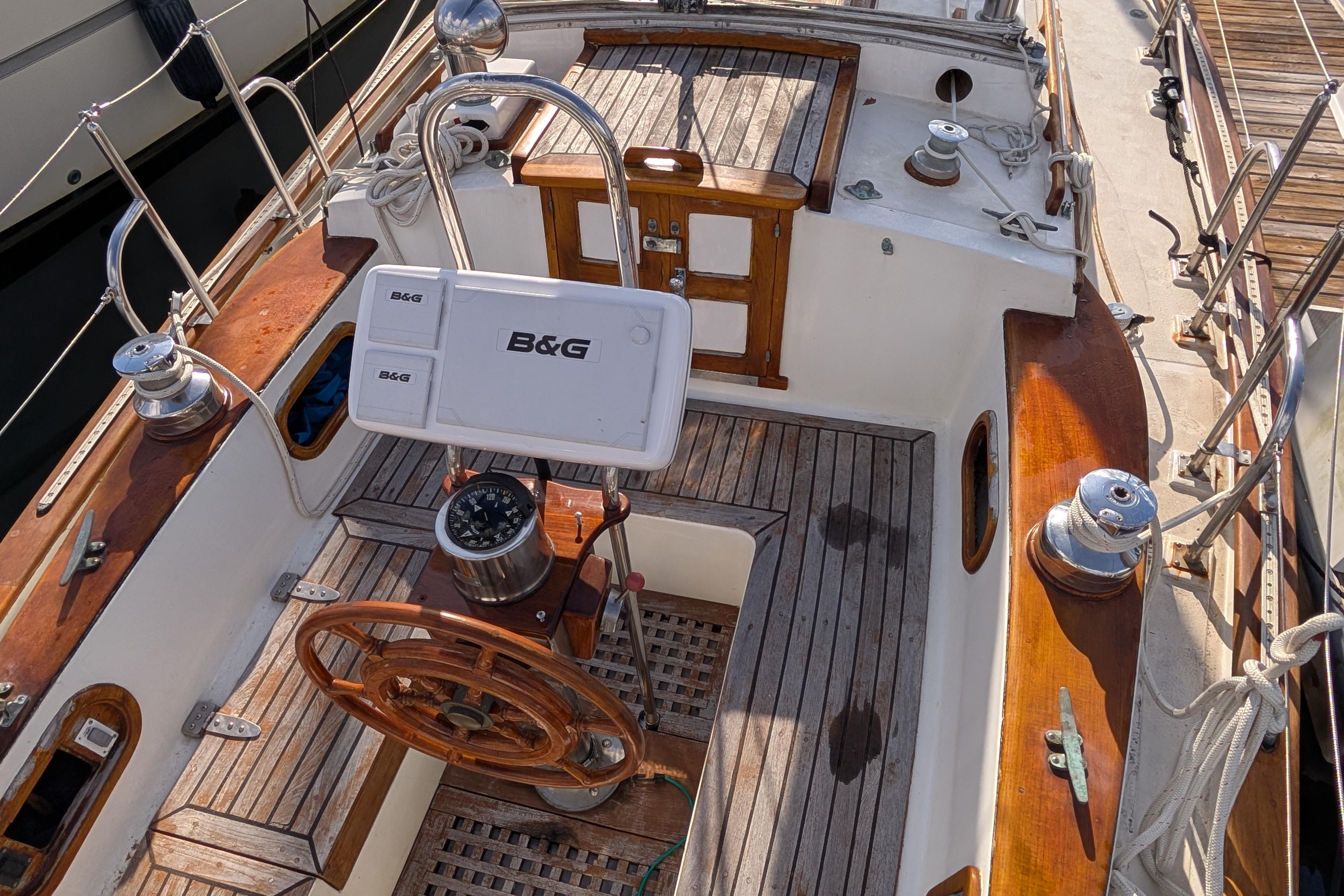 Cockpit of 1983 Robert Perry 41 sailboat with wooden accents and B&G navigation equipment.