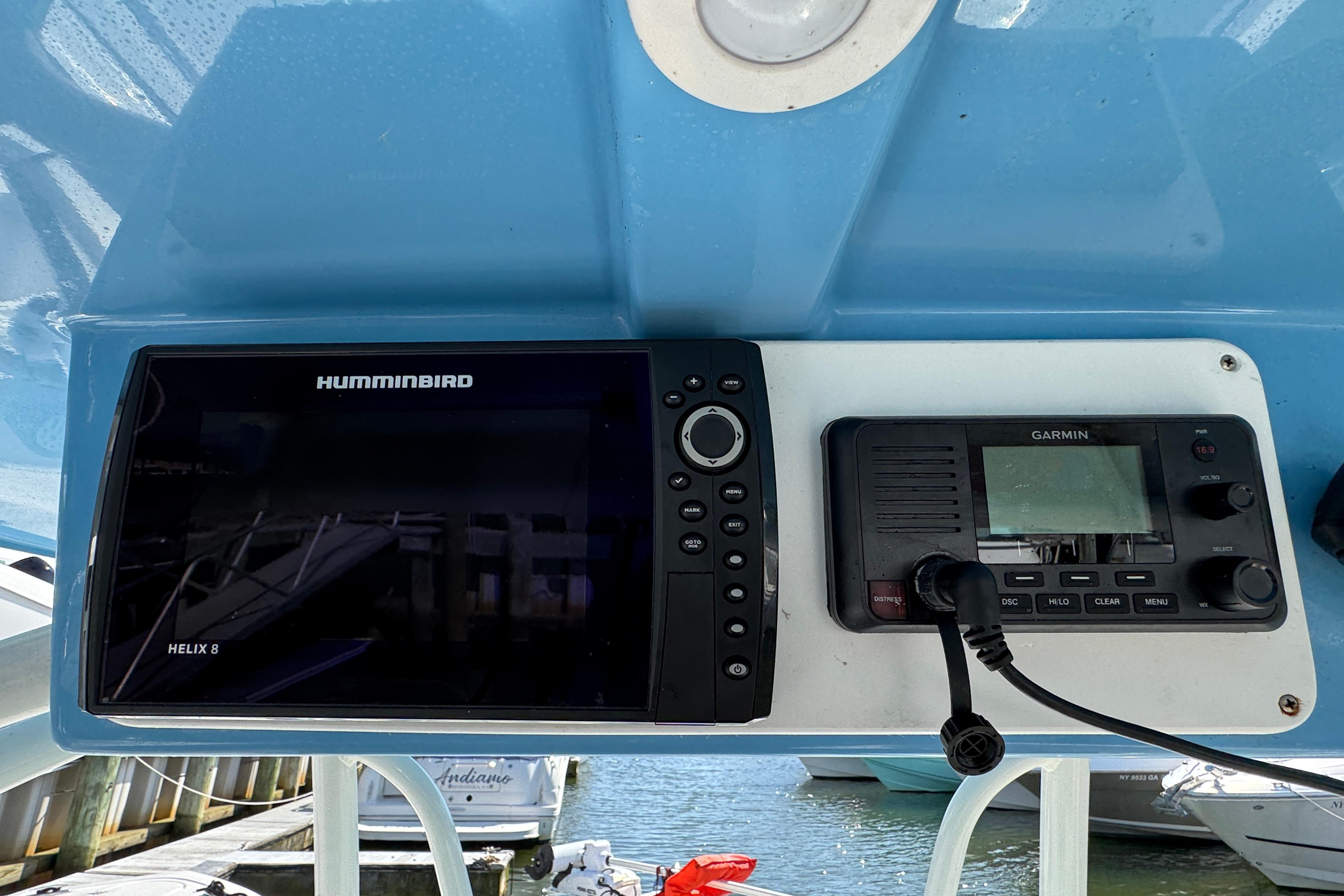 Helm of 2022 Sailfish 242 CC with Humminbird and Garmin navigation systems.