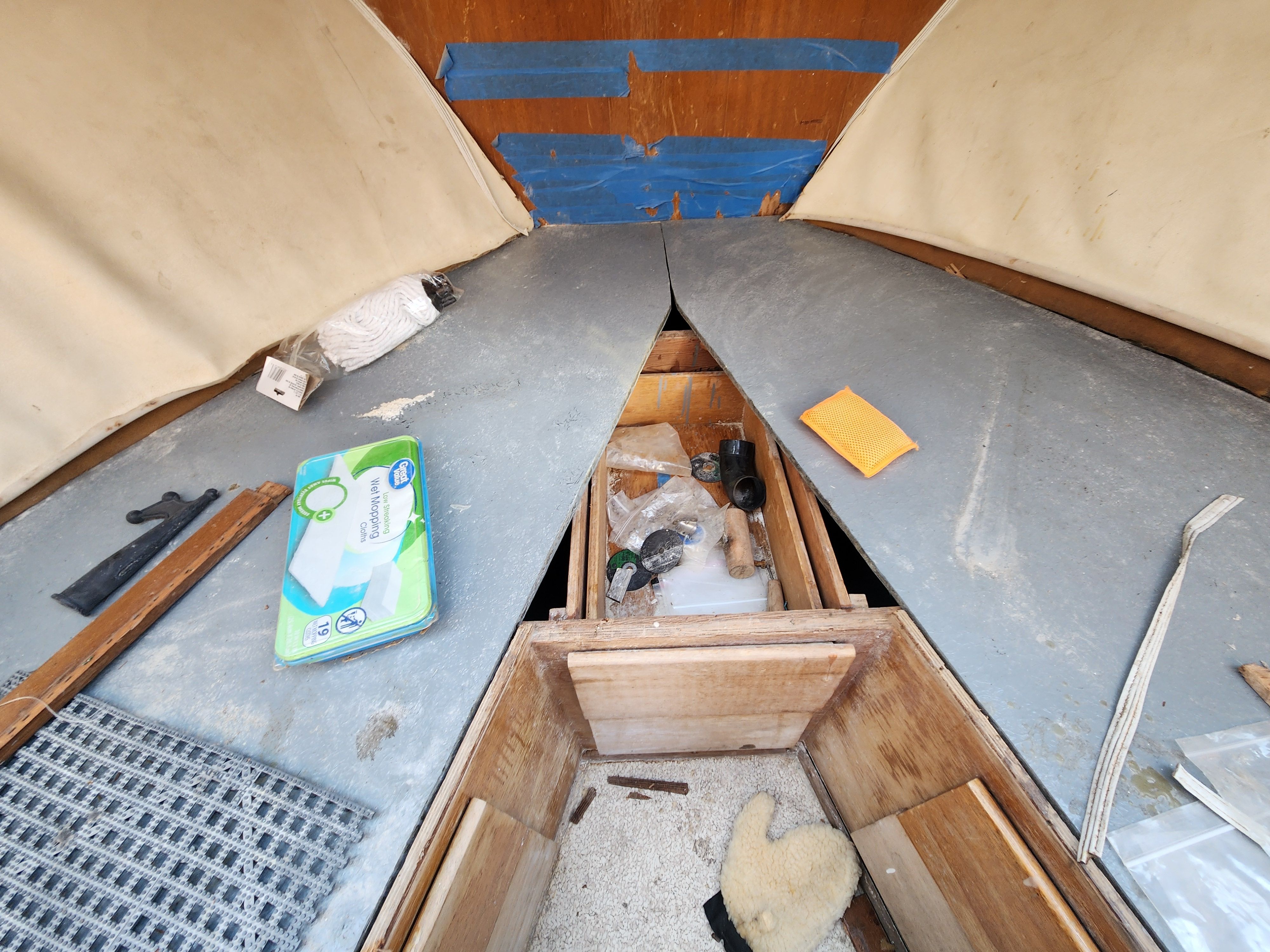 Interior of a 1967 Hatteras 28ft boat with tools and materials.