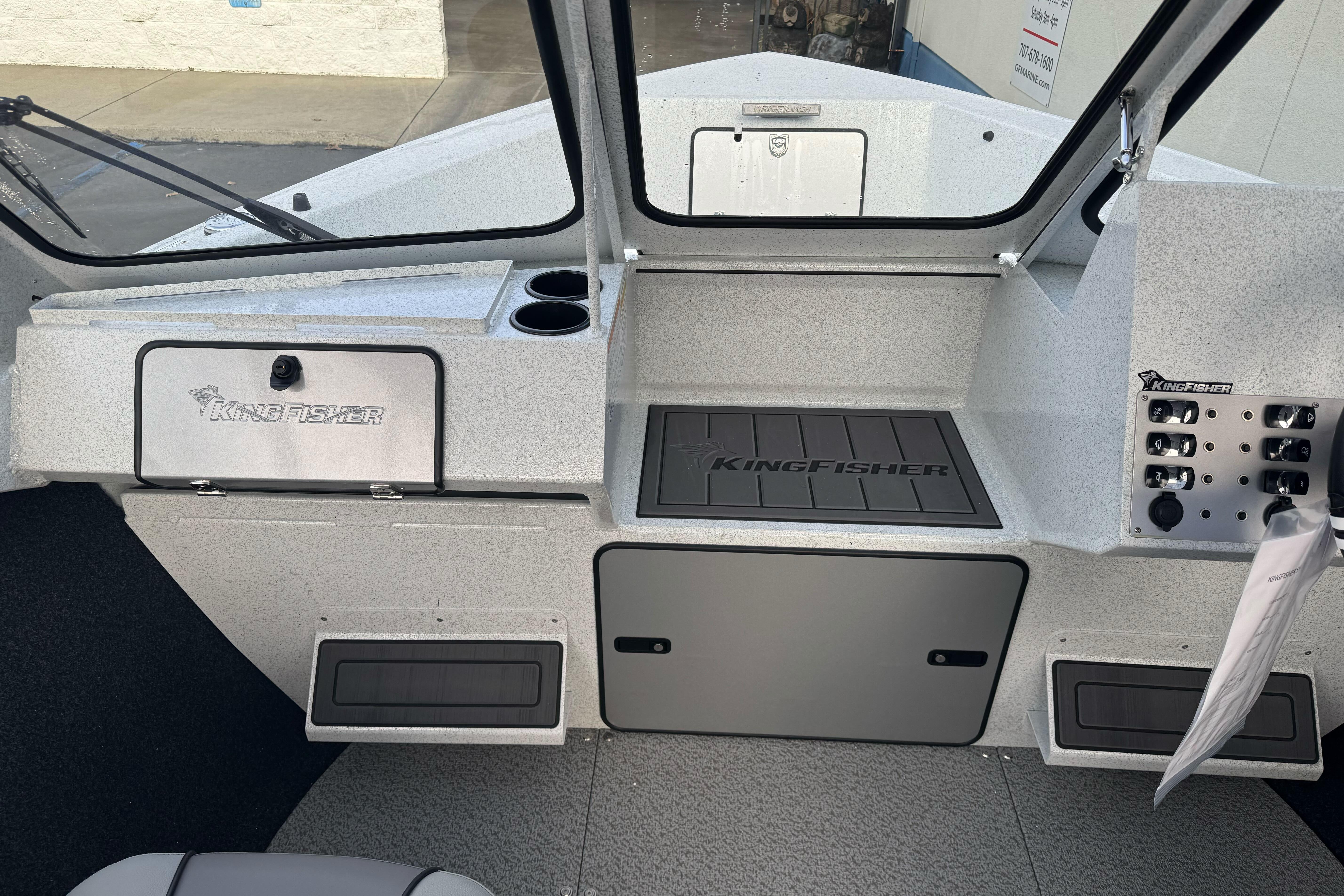 Interior of 2026 KingFisher 2025 Escape boat, featuring control panel and storage compartments.
