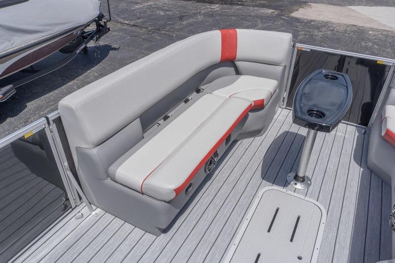 2026 SunCatcher Select 322SL pontoon boat interior with gray and red seating, and table.