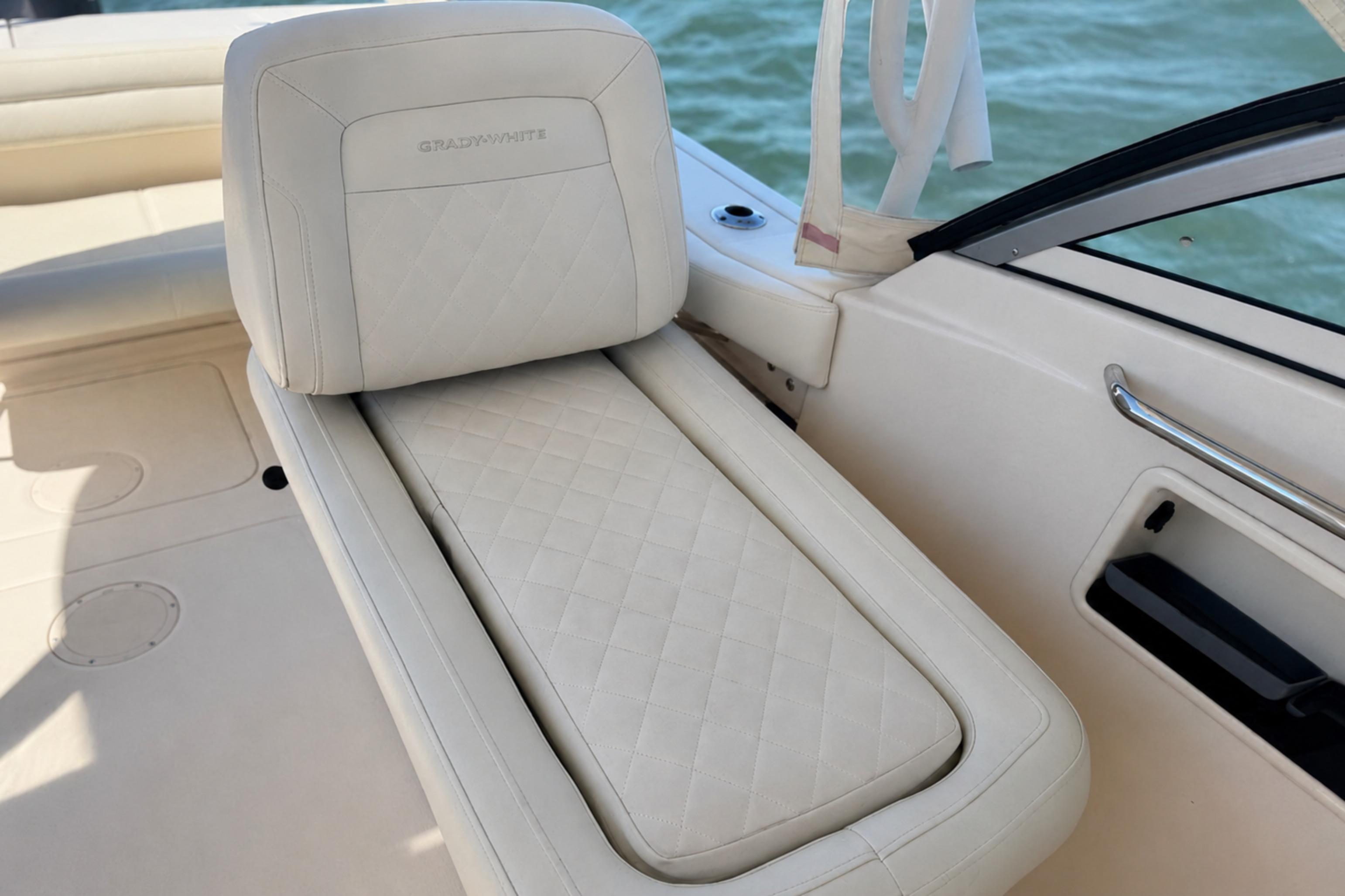 Luxurious seating on a 2017 Grady-White Freedom 235 boat, featuring elegant white upholstery.