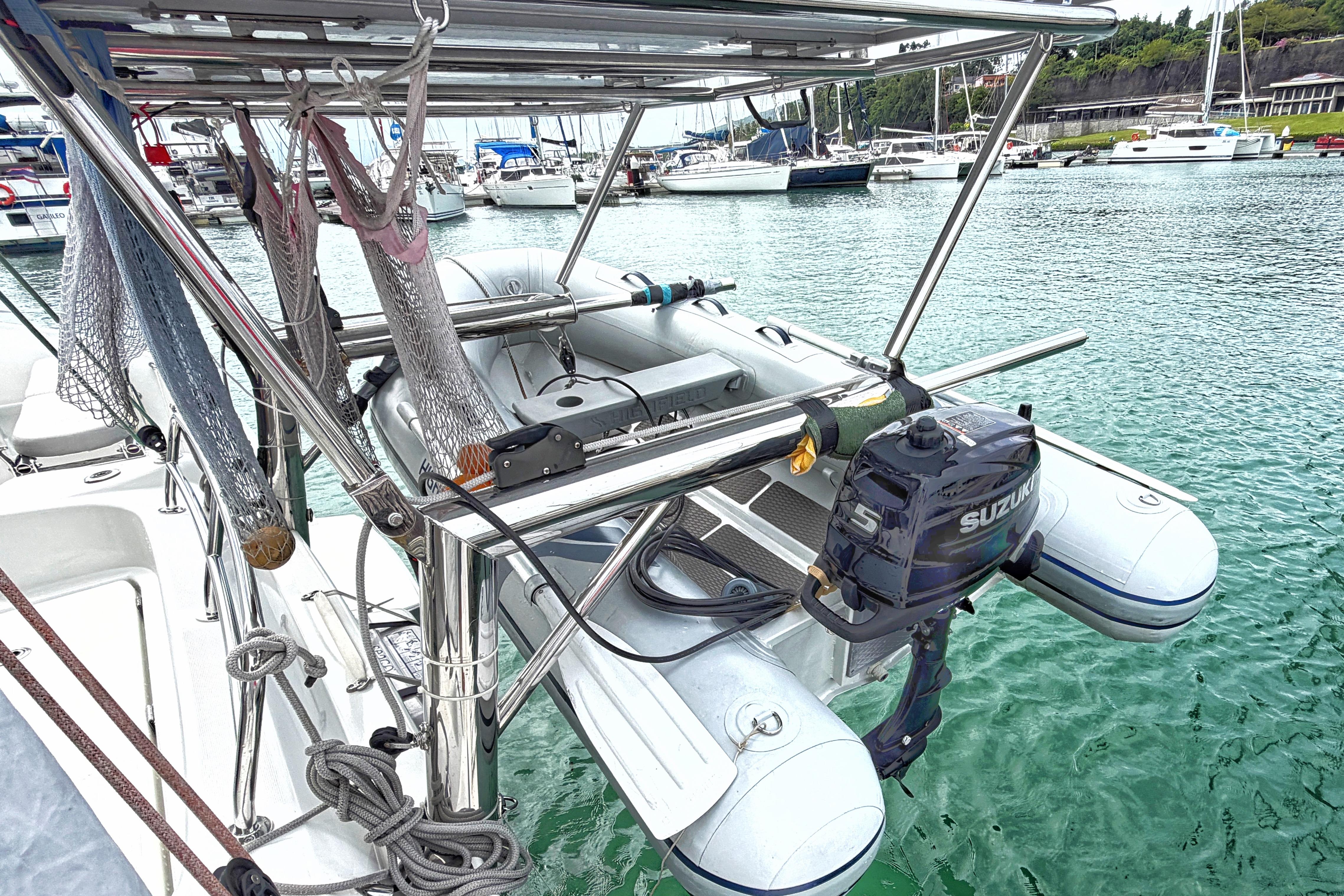 2024 Excess 11 yacht with Suzuki outboard motor in marina setting.