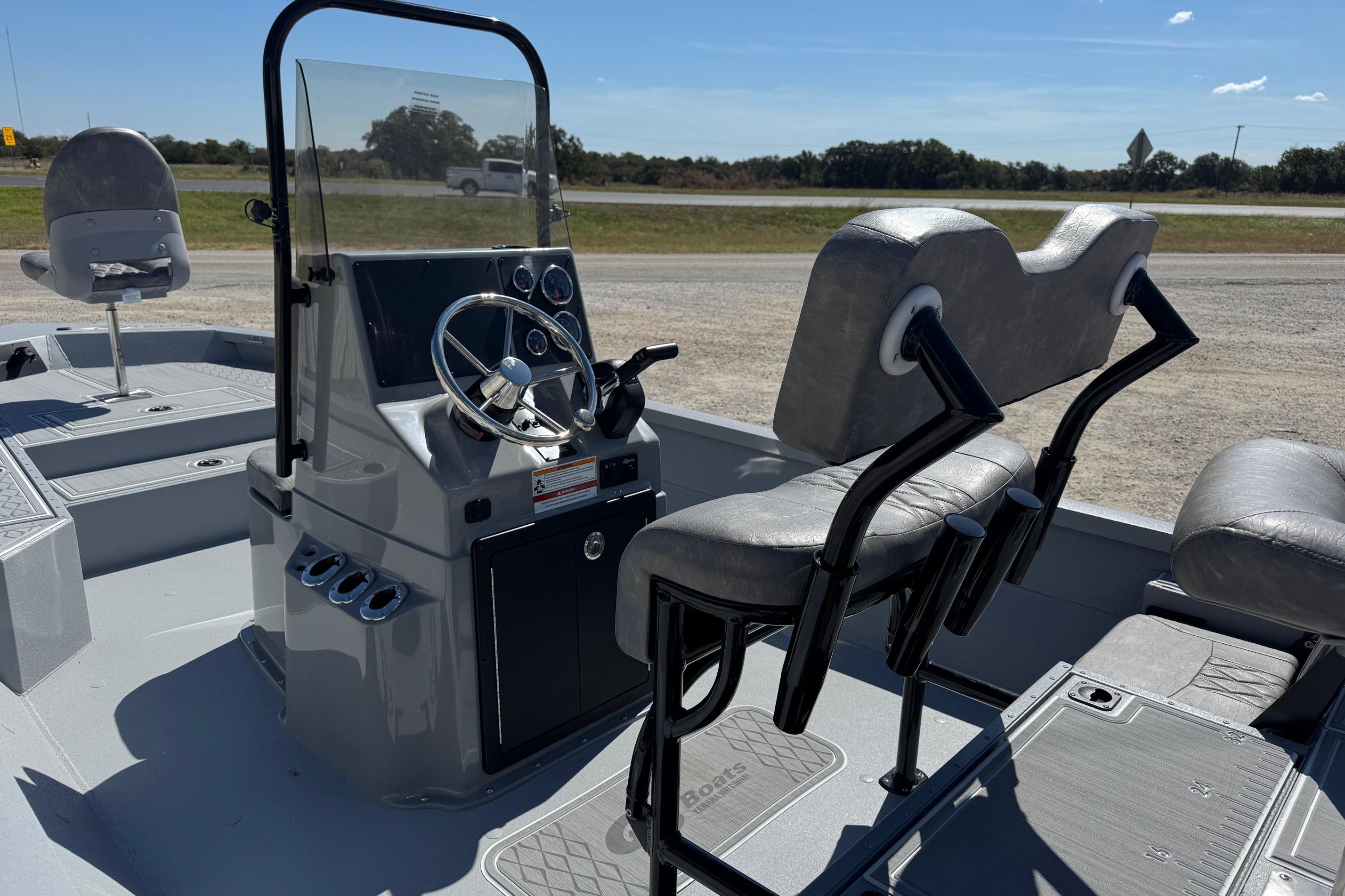 2026 G3 21GX boat interior with steering console and seating, under clear blue sky.