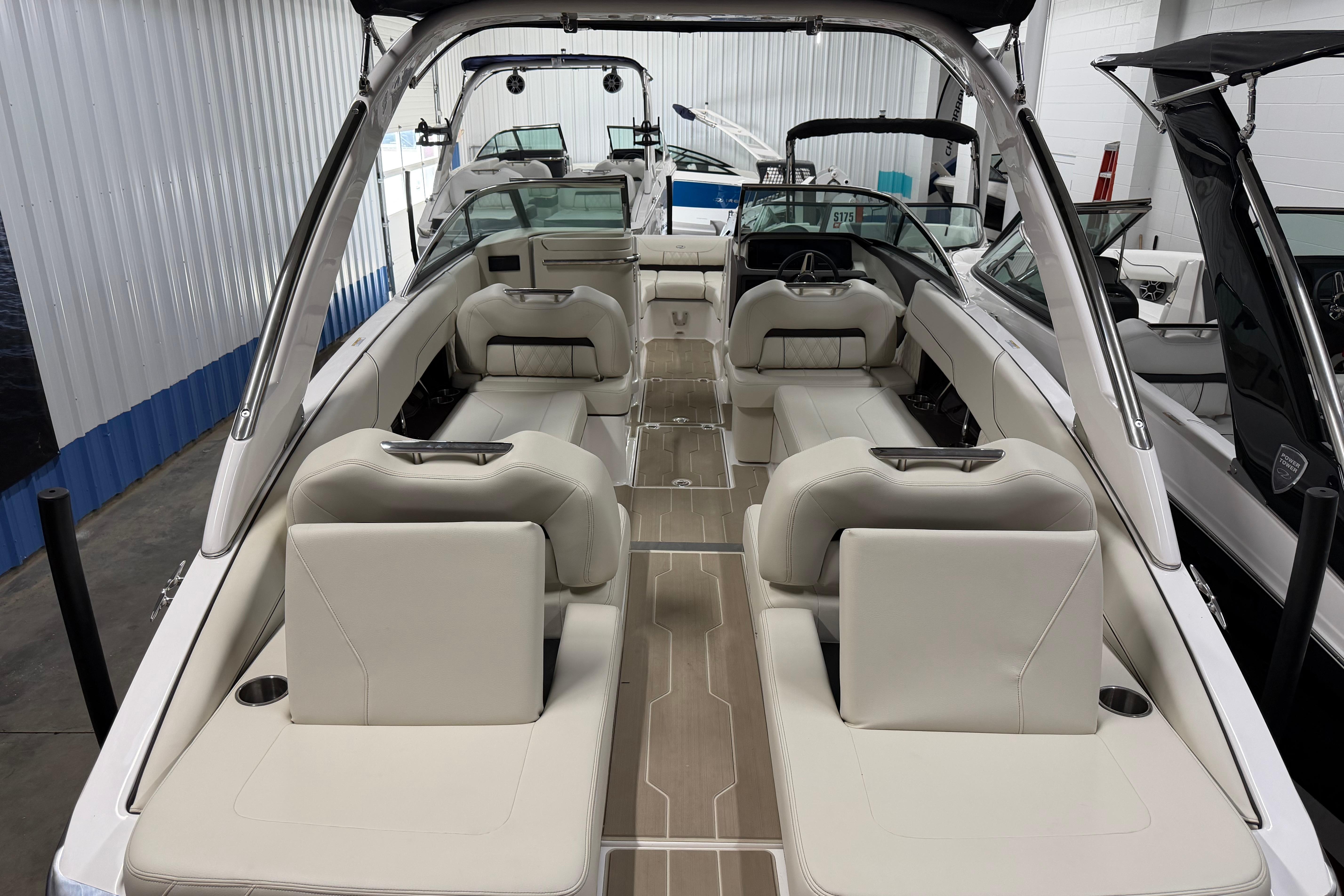 2026 Regal LS6 boat interior with luxurious seating and modern design in a showroom.
