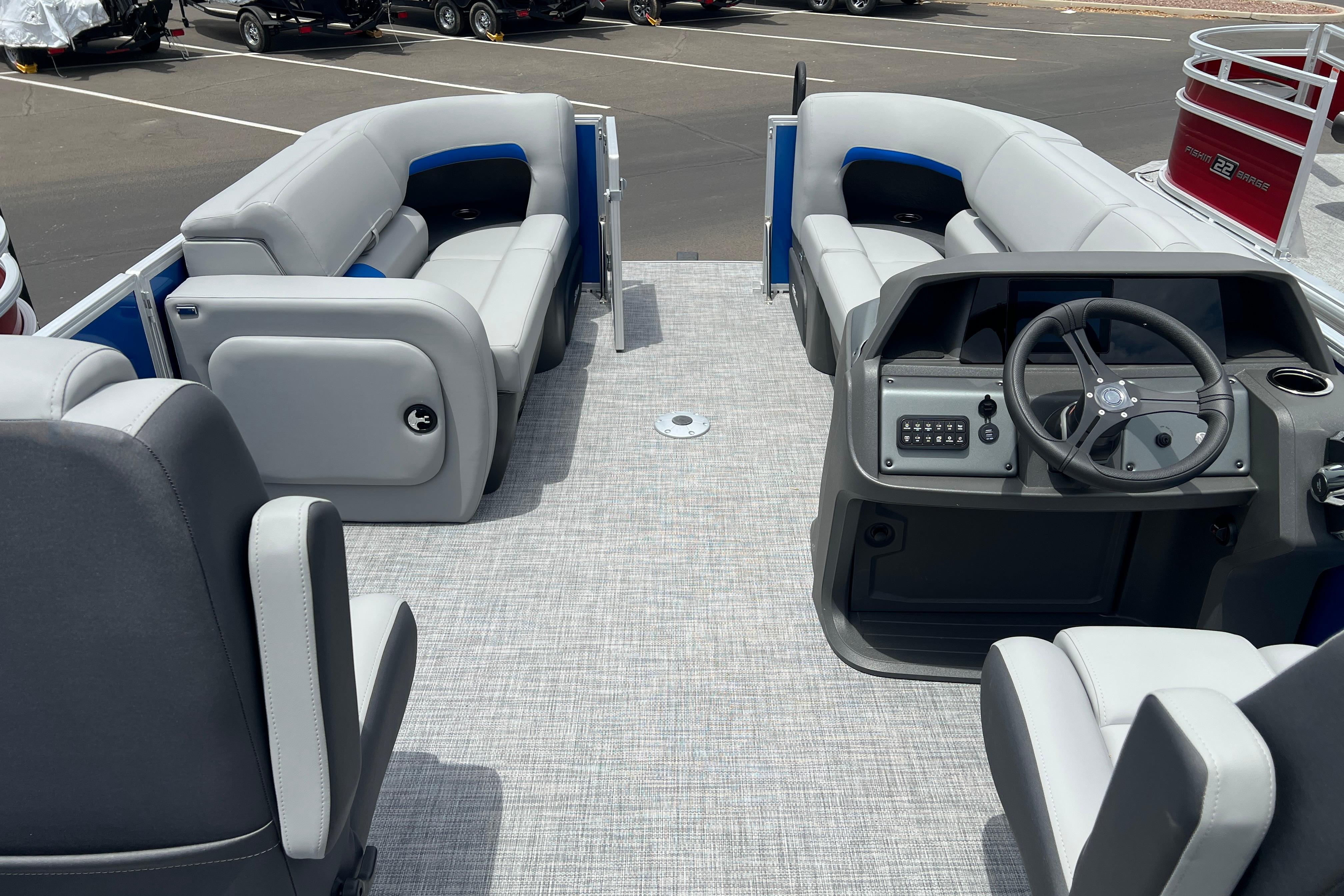 2026 Sun Tracker Party Barge 22 RF DLX interior with seating and steering console.