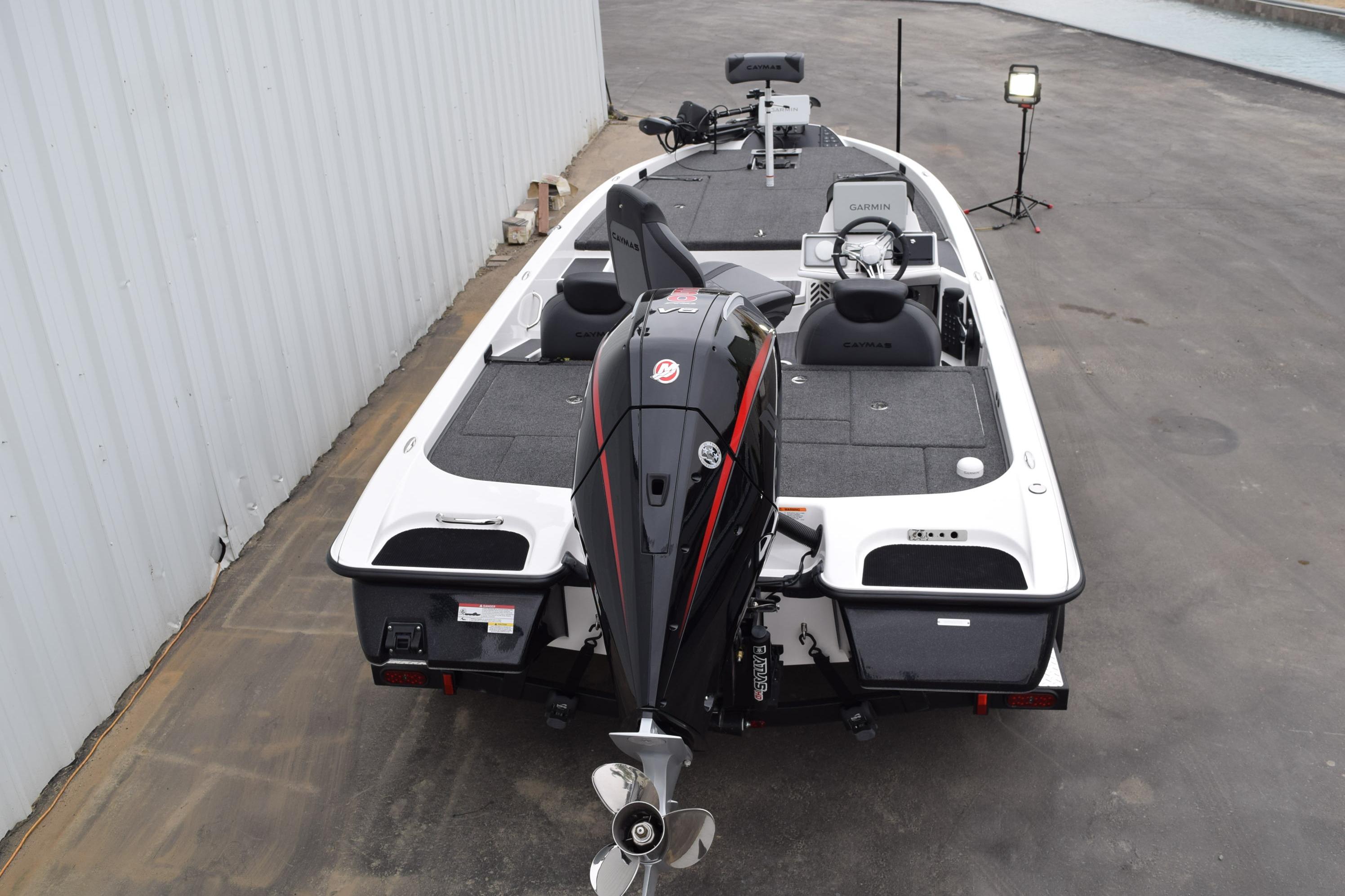 2027 Cayams CX 20 Pro boat with powerful outboard motor, parked on concrete surface.