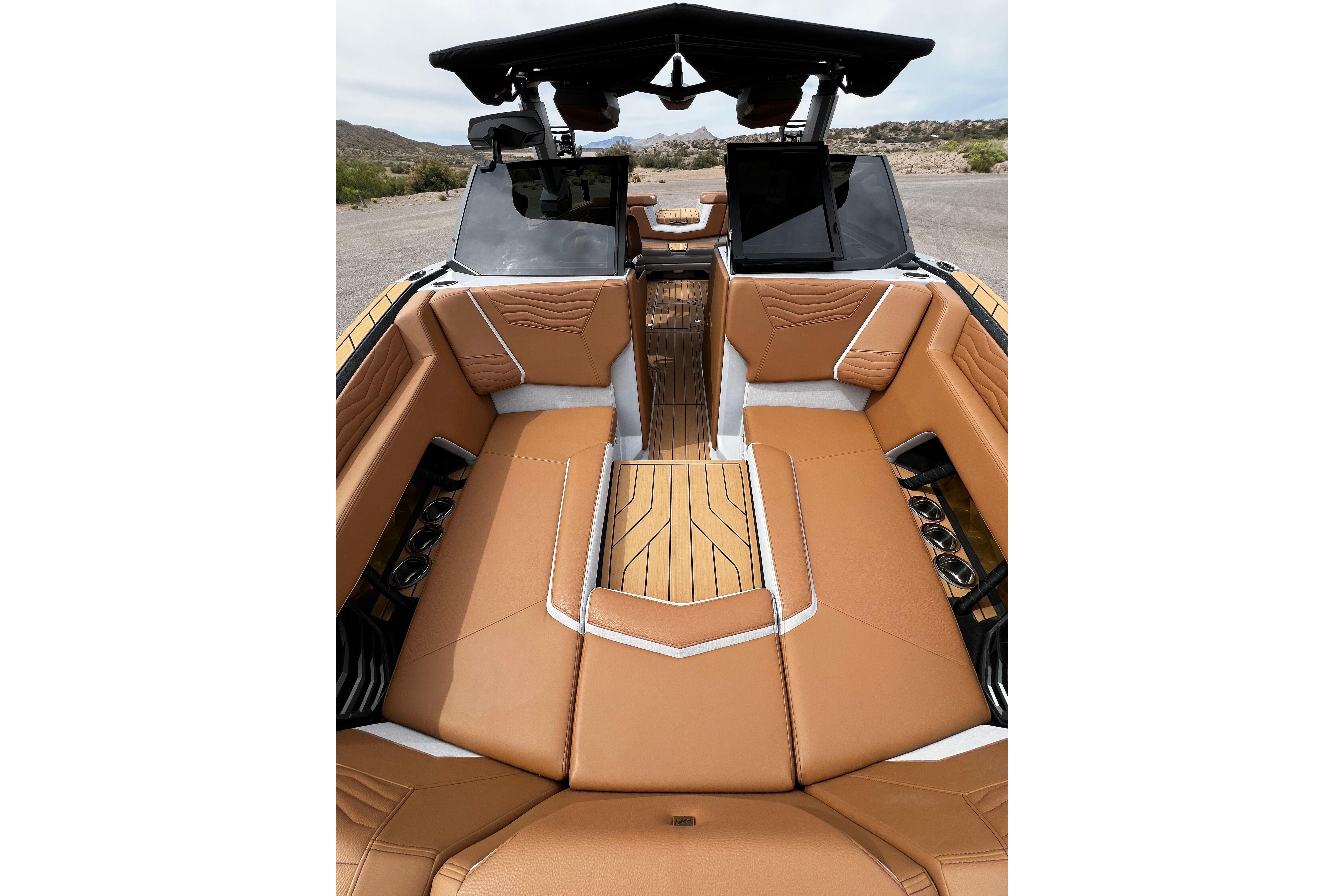 Luxurious interior of 2026 Nautique Super Air Nautique G25 boat with tan seating.