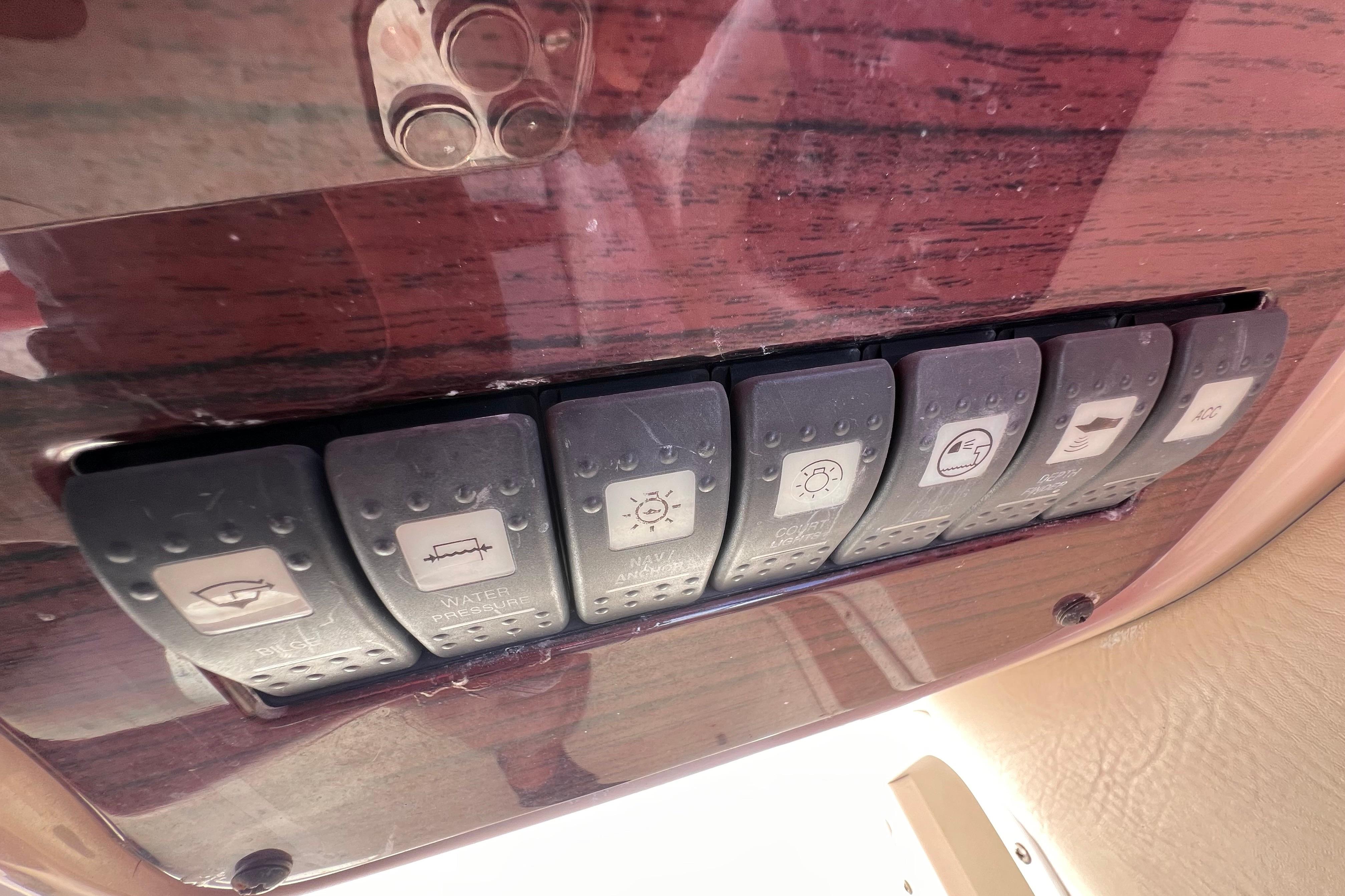 Control panel switches on a 2002 Chaparral 232 Sunesta boat dashboard.