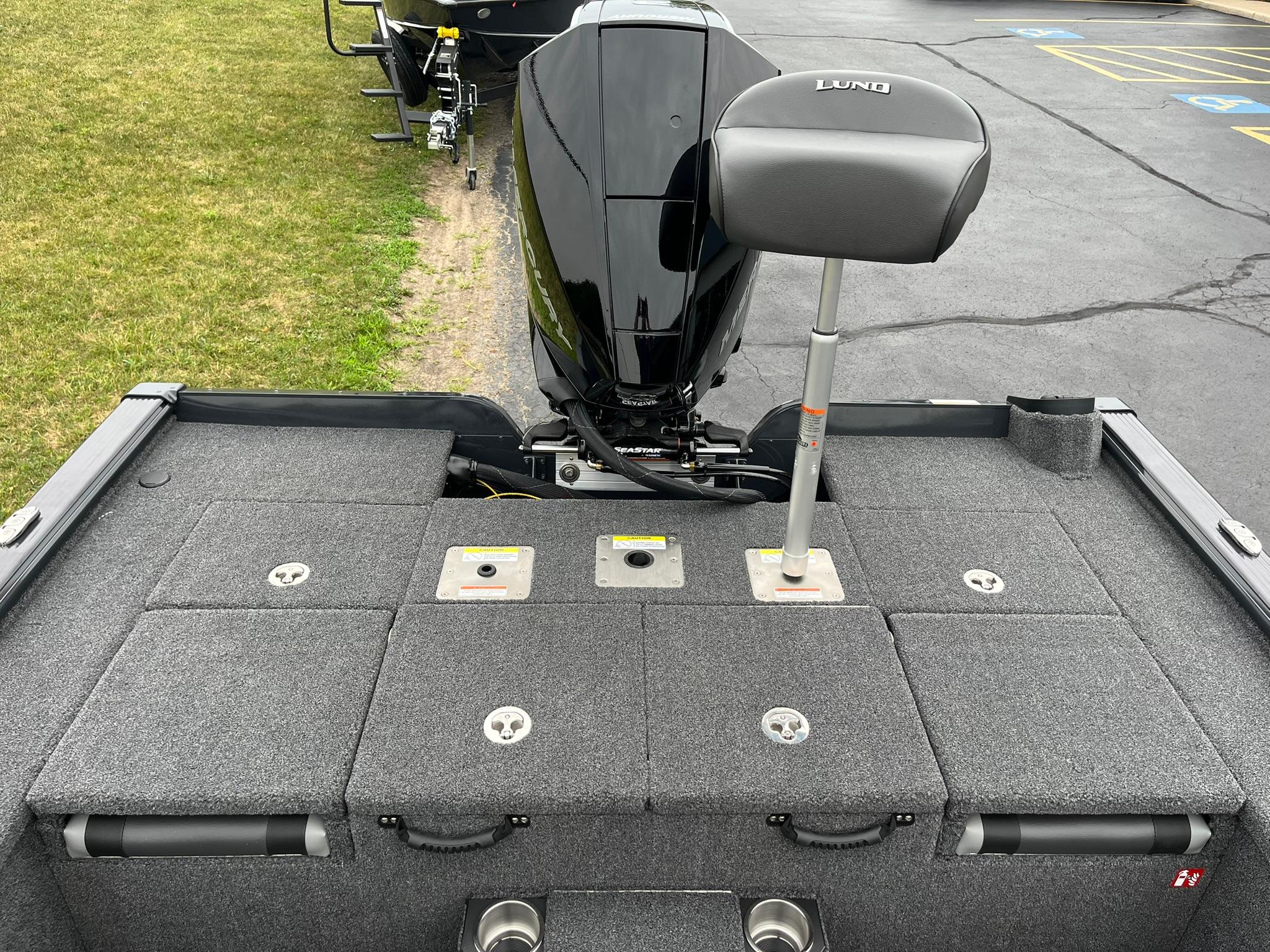 2026 Lund 1875 Pro-V Bass XS boat deck with motor and seating.