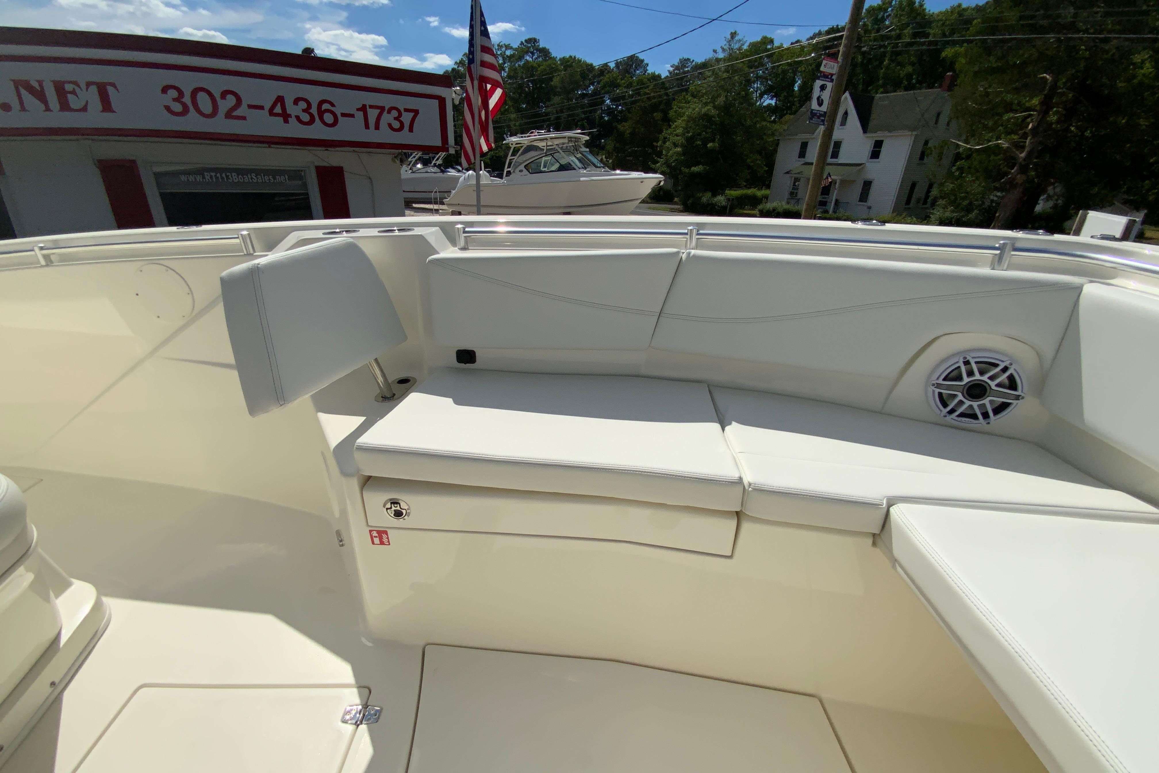 2027 Cobia 320 Center Console boat interior with cushioned seating and speaker.