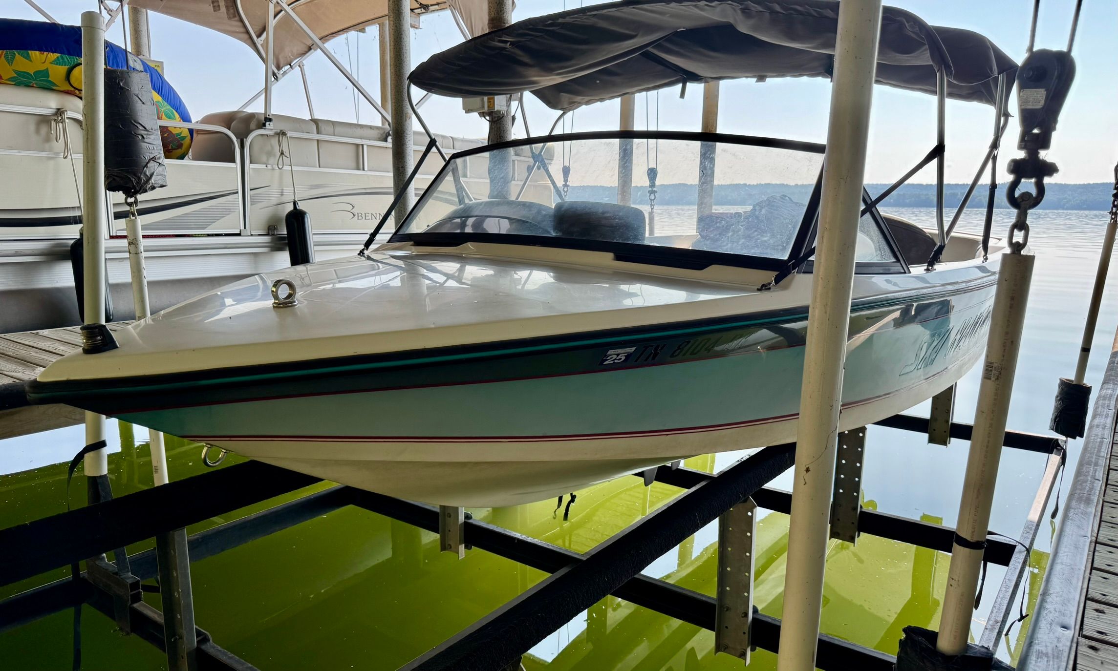 1991 Correct Craft Ski Nautique boat on a lift.