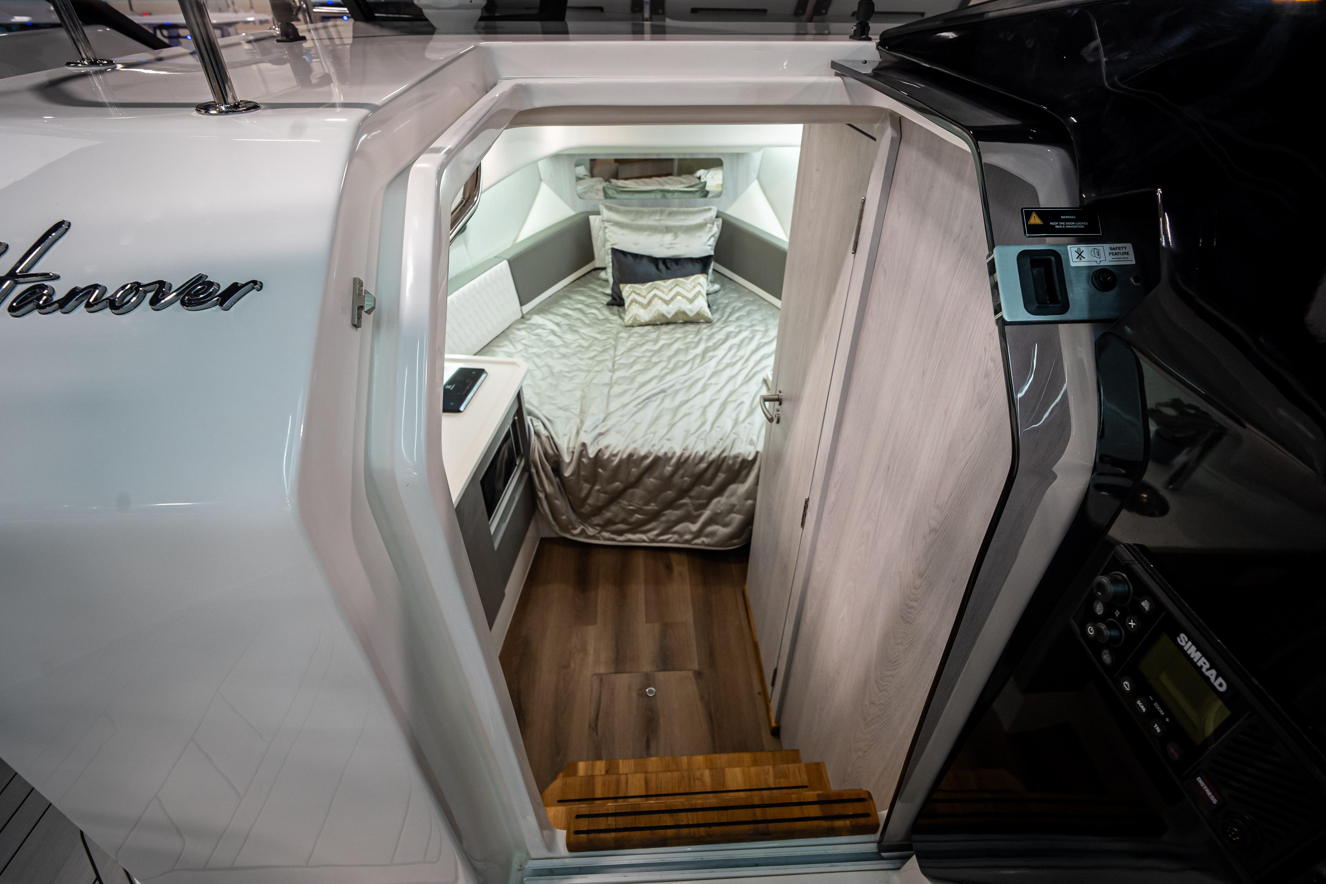 Interior cabin of 2026 Hanover 347 boat with cozy bed and modern design.
