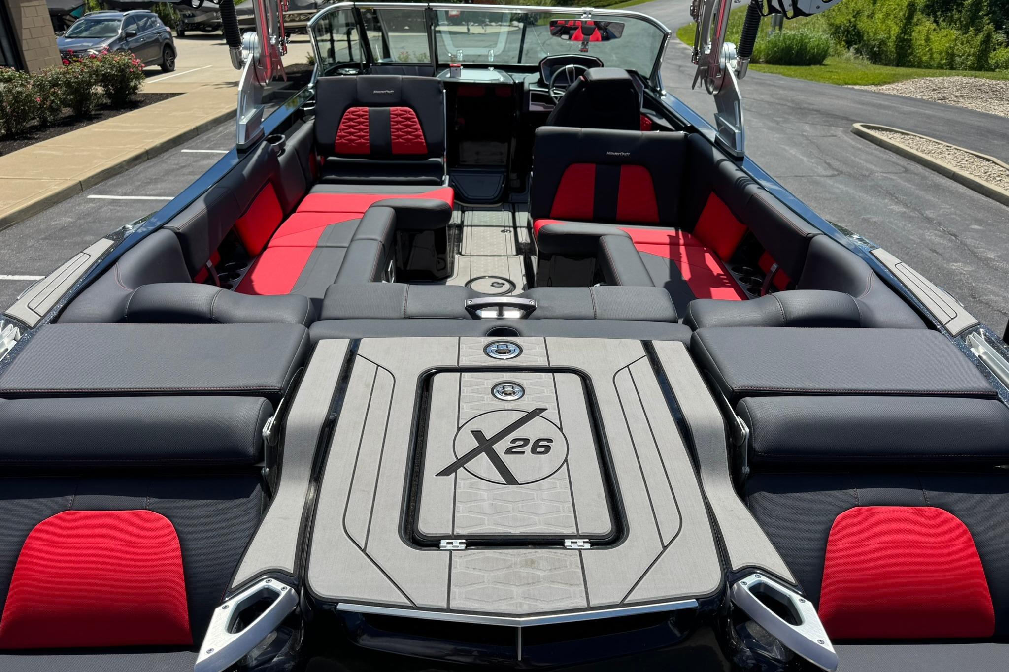 2021 MasterCraft X26 boat interior with red and gray seating, showcasing luxury design.