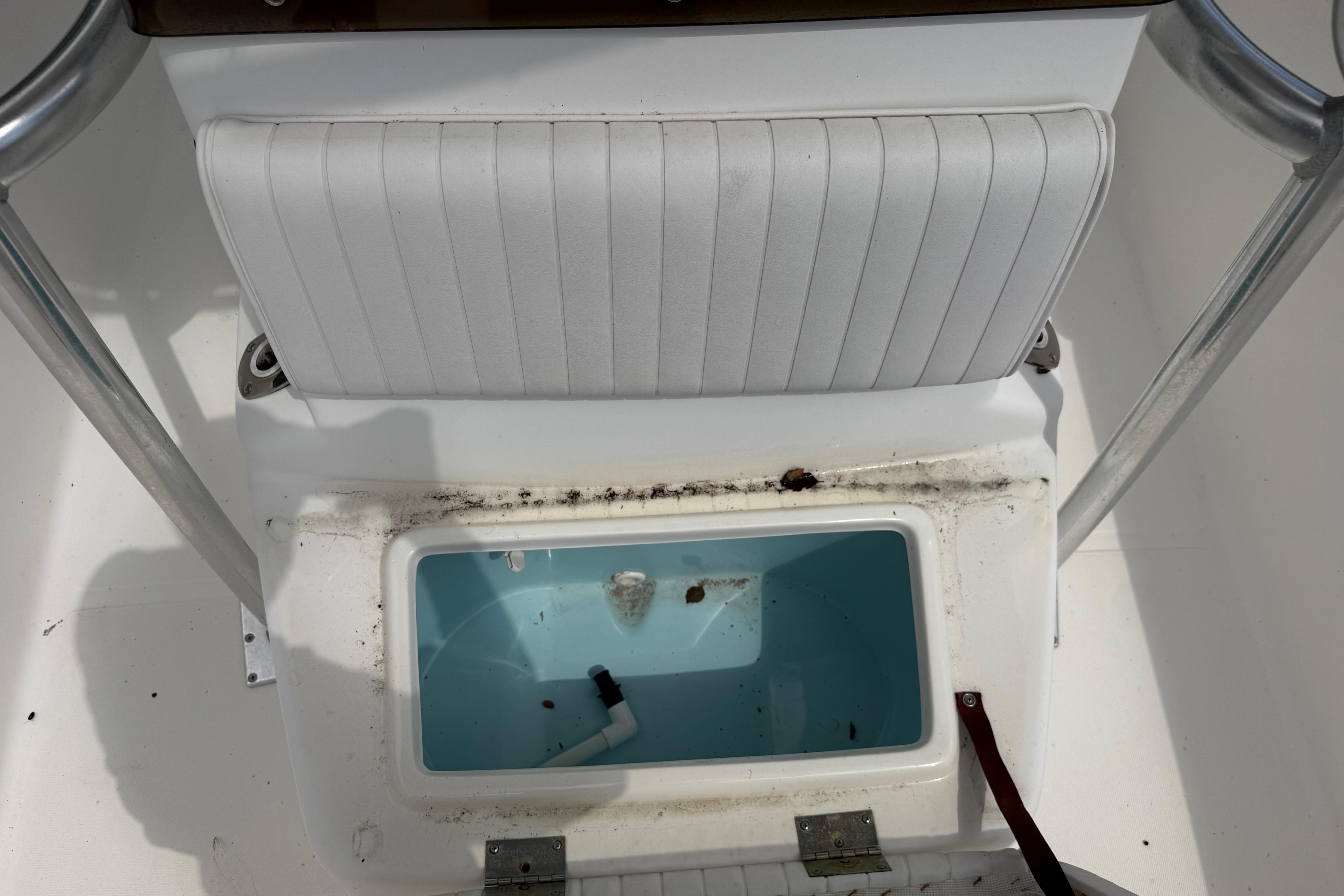 Interior of a 2012 Clearwater 2000 Center Console boat with storage compartment.