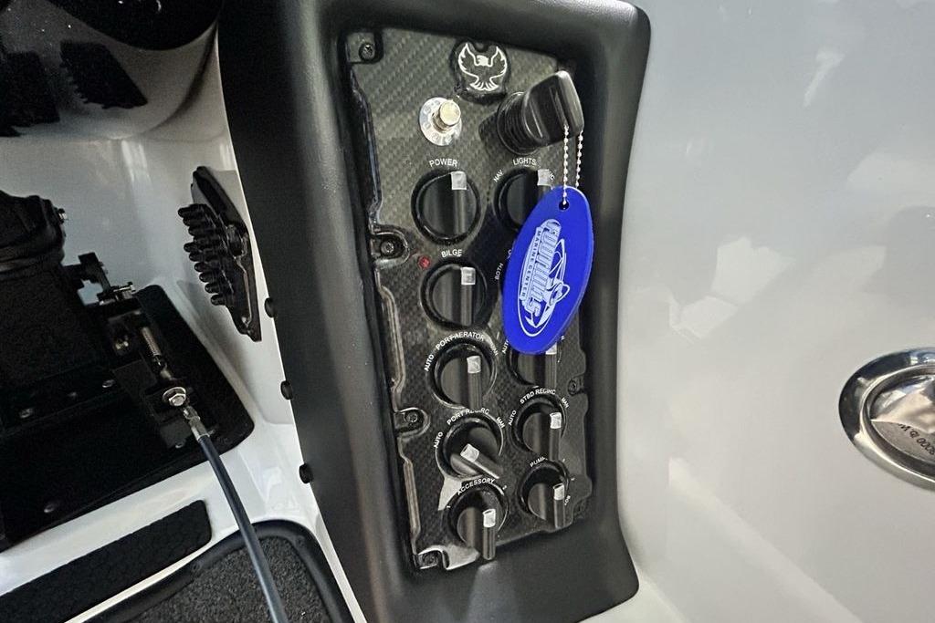 Control panel of 2026 Phoenix 818 Pro boat with switches and keychain.