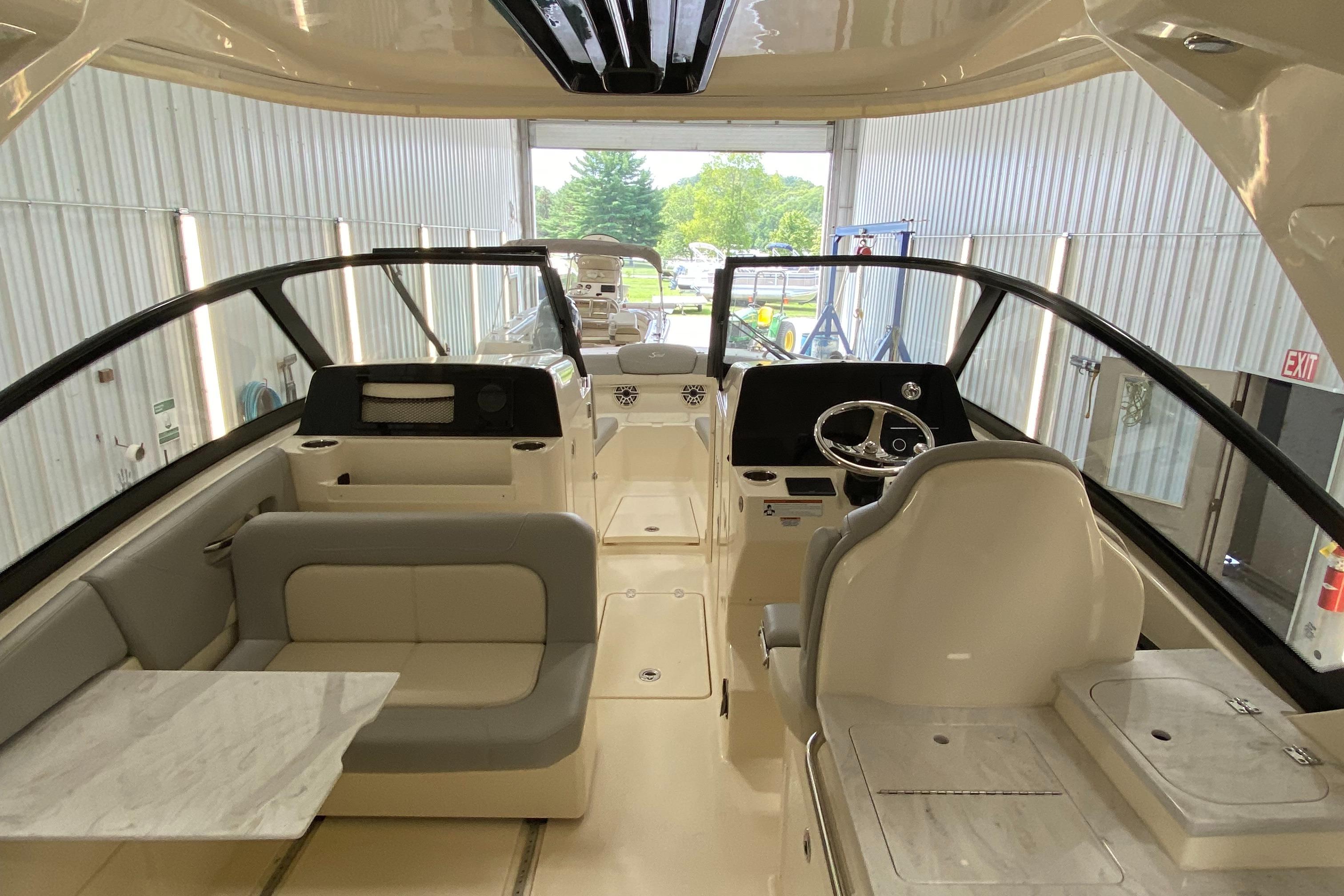 2022 Scout 277 Dorado boat interior with seating and steering console.