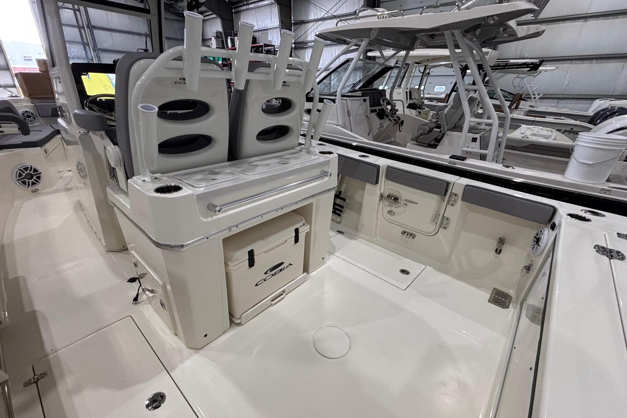 2026 Cobia 285 Open Center Console boat interior with seating and storage features.