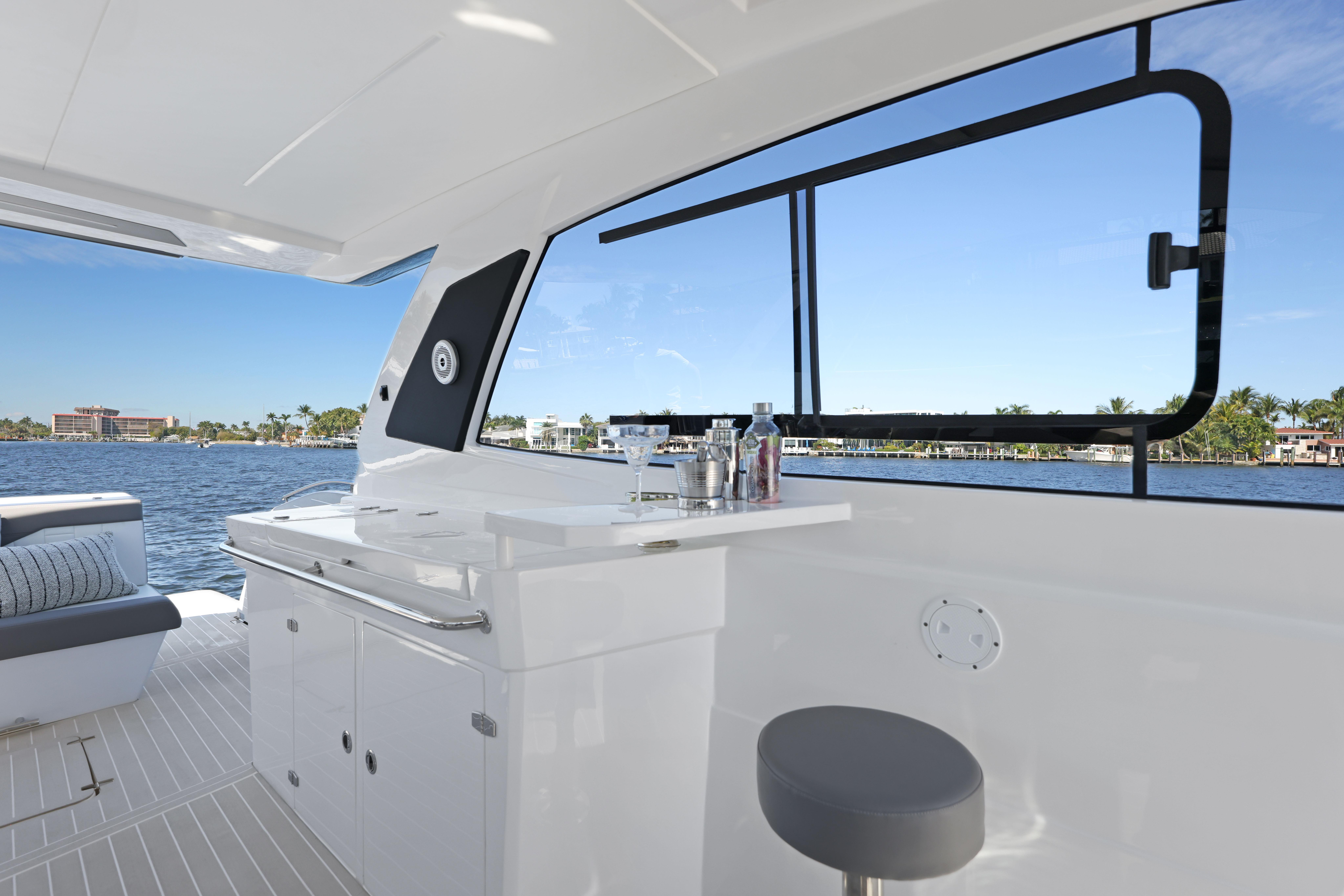 Interior of 2025 Valiatt 380 Bowrider yacht with bar and seating, overlooking water.