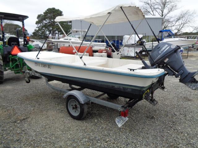 2010 Sundance K14T boat with Yamaha motor on trailer, parked outdoors.