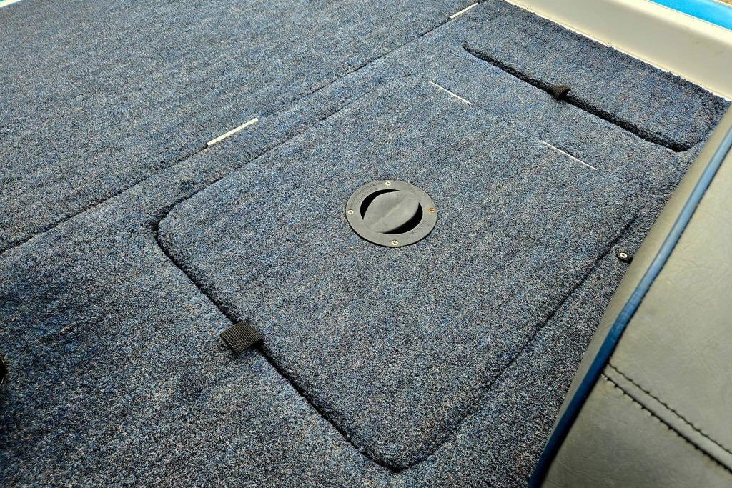 Carpeted deck of a 1996 Champion 181 SX boat with storage hatch.