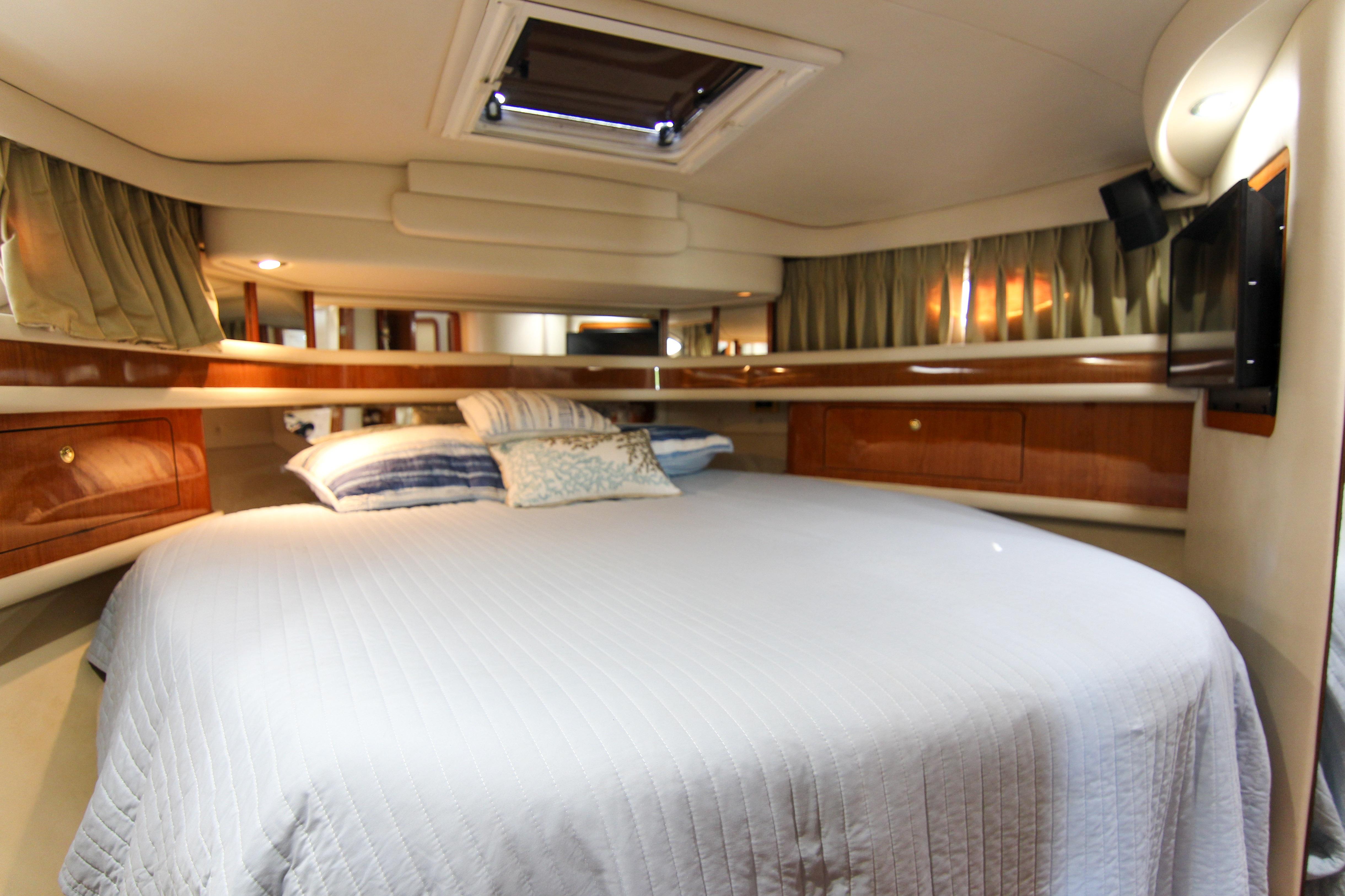 Luxurious bedroom interior of 2000 Sea Ray 450 Express Bridge yacht.