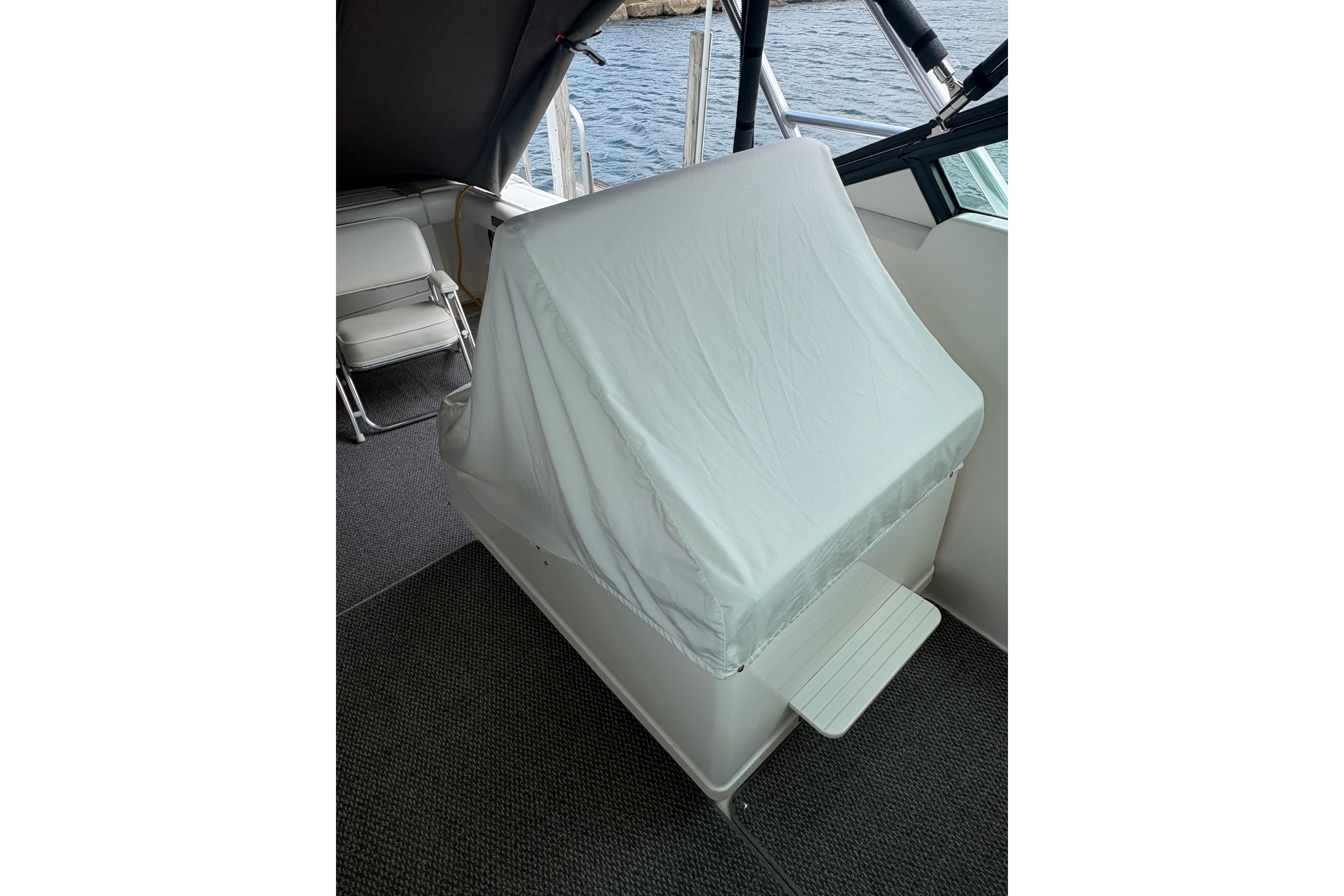 1999 Tiara Yachts 3100 Open helm covered, showcasing cockpit area and seating.