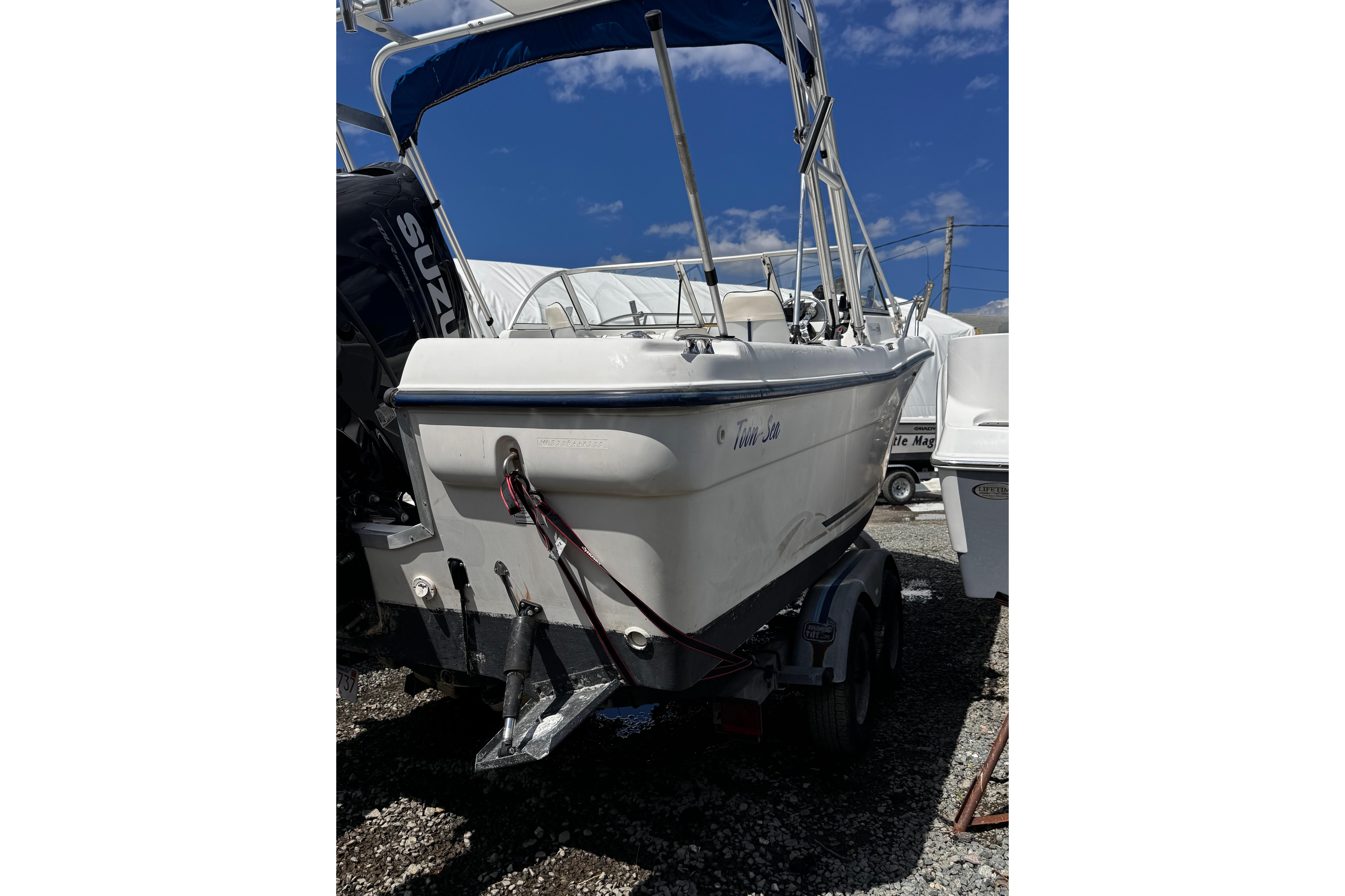 2003 Palm Beach 2200 Dual Console boat on trailer under blue sky.