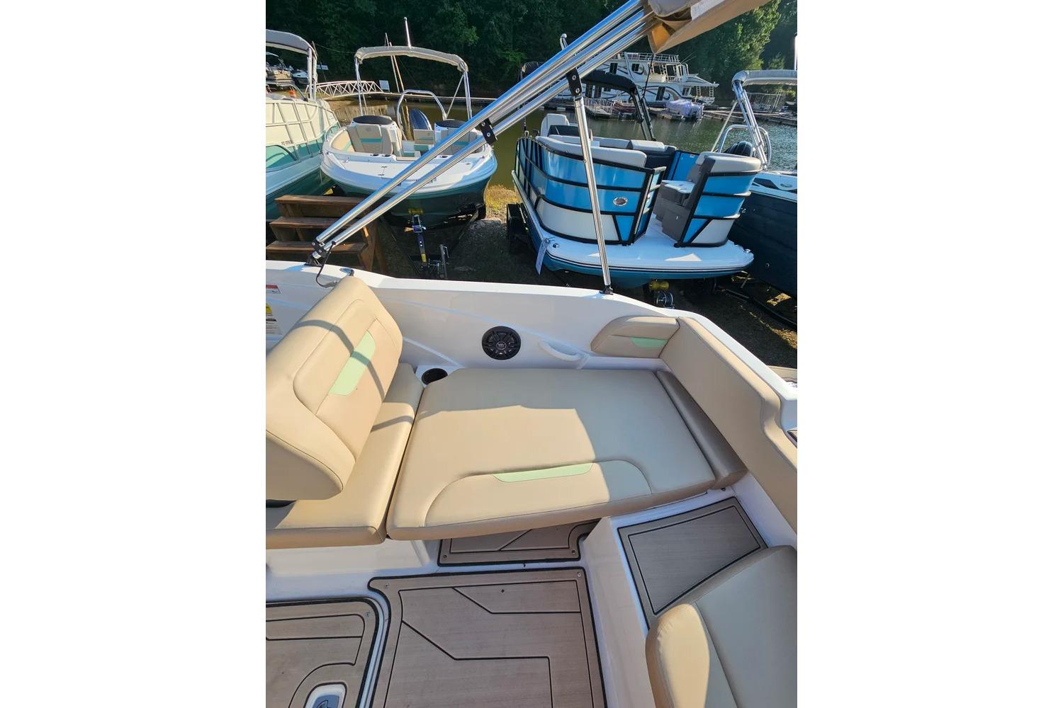 2025 Hurricane SunDeck Sport 205 OB boat interior with beige seating and sleek design.