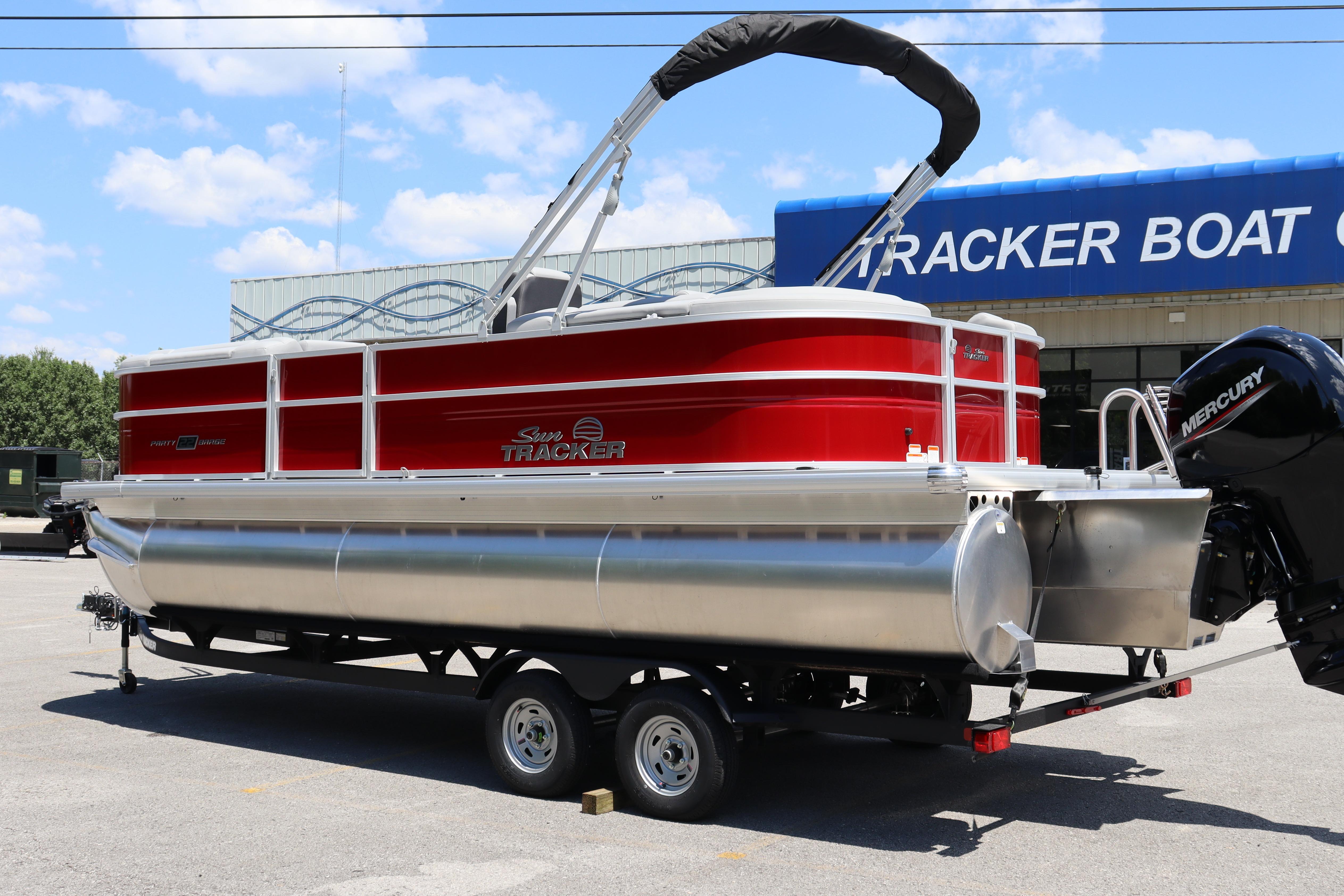 2026 Sun Tracker Party Barge 22 XP3 pontoon boat, red and silver, on trailer.