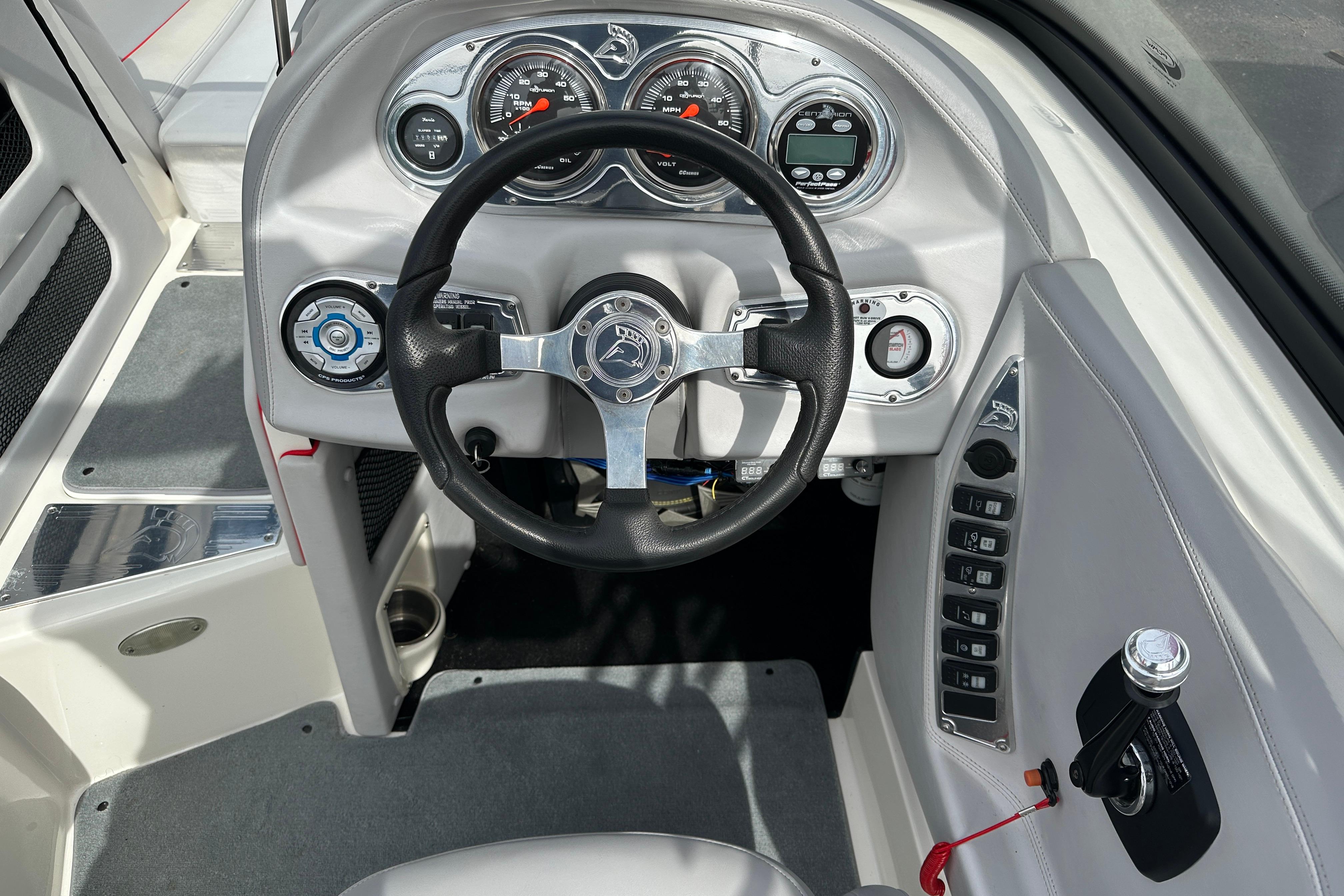 2008 Centurion Enzo SV240 boat dashboard with steering wheel and control panel.