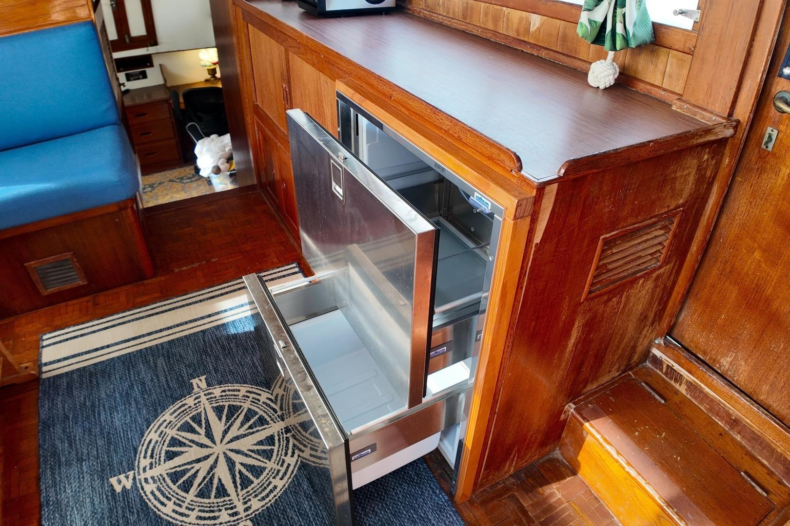 1978 Grand Banks 42 Classic interior with open stainless steel drawer fridge.