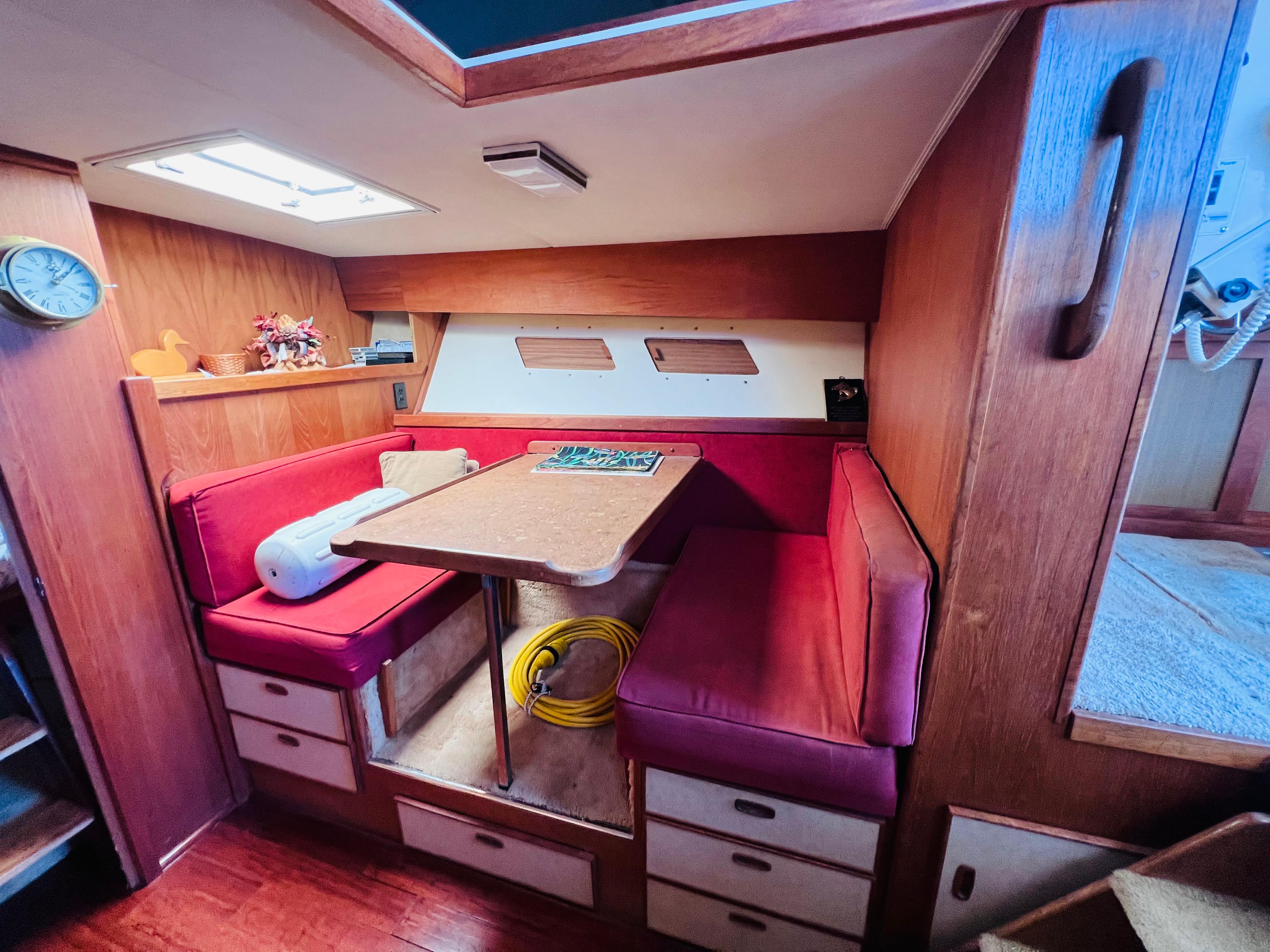 Cozy 1982 Trojan F32 boat interior with red seating and wooden accents.
