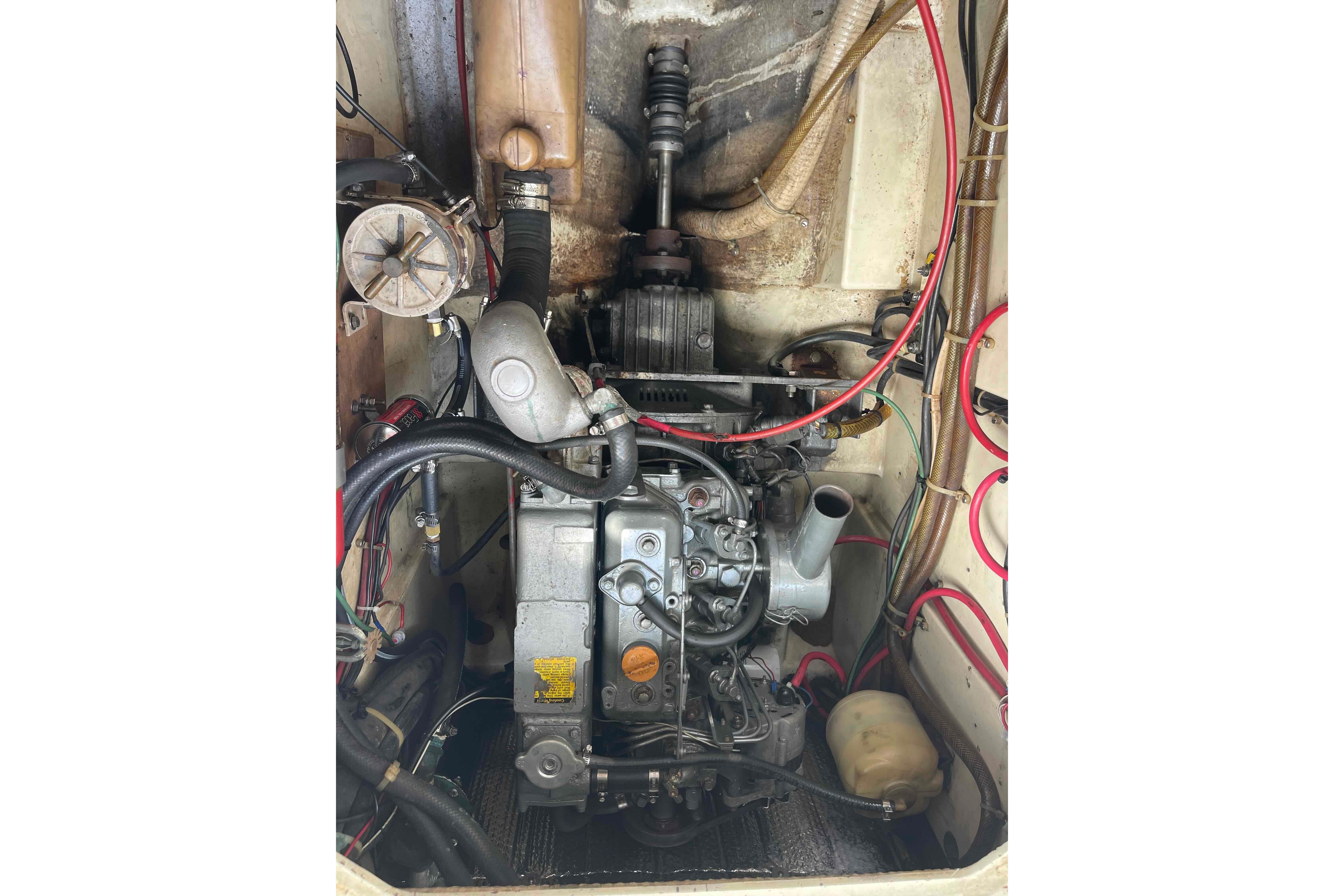 Engine compartment of a 1987 Pacific Seacraft 34 sailboat, showing detailed mechanical components.