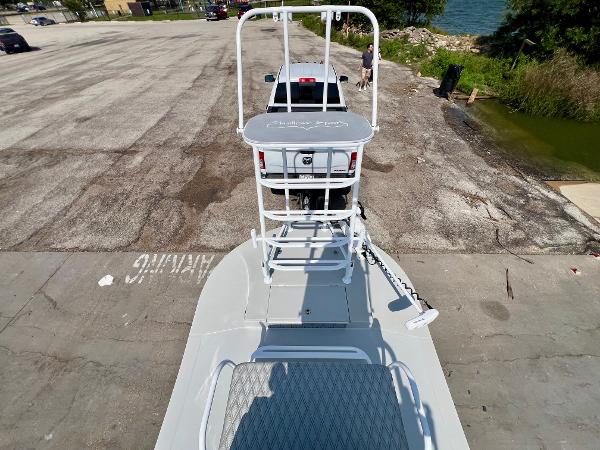2022 Shallow Sport 20 Classic boat on trailer at a lakeside parking area.