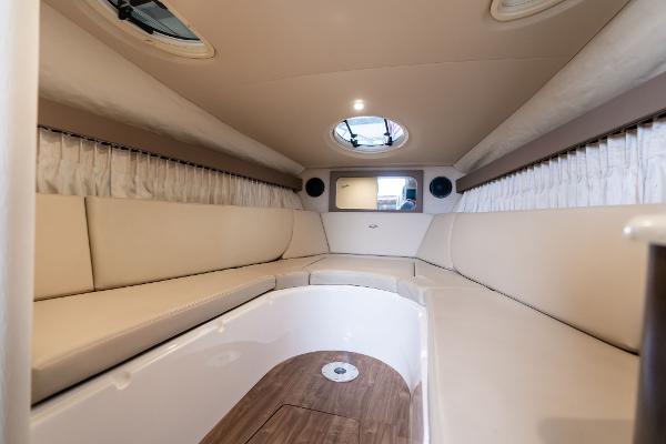 2016 Regal 28 Express cabin interior with beige seating and wood flooring.