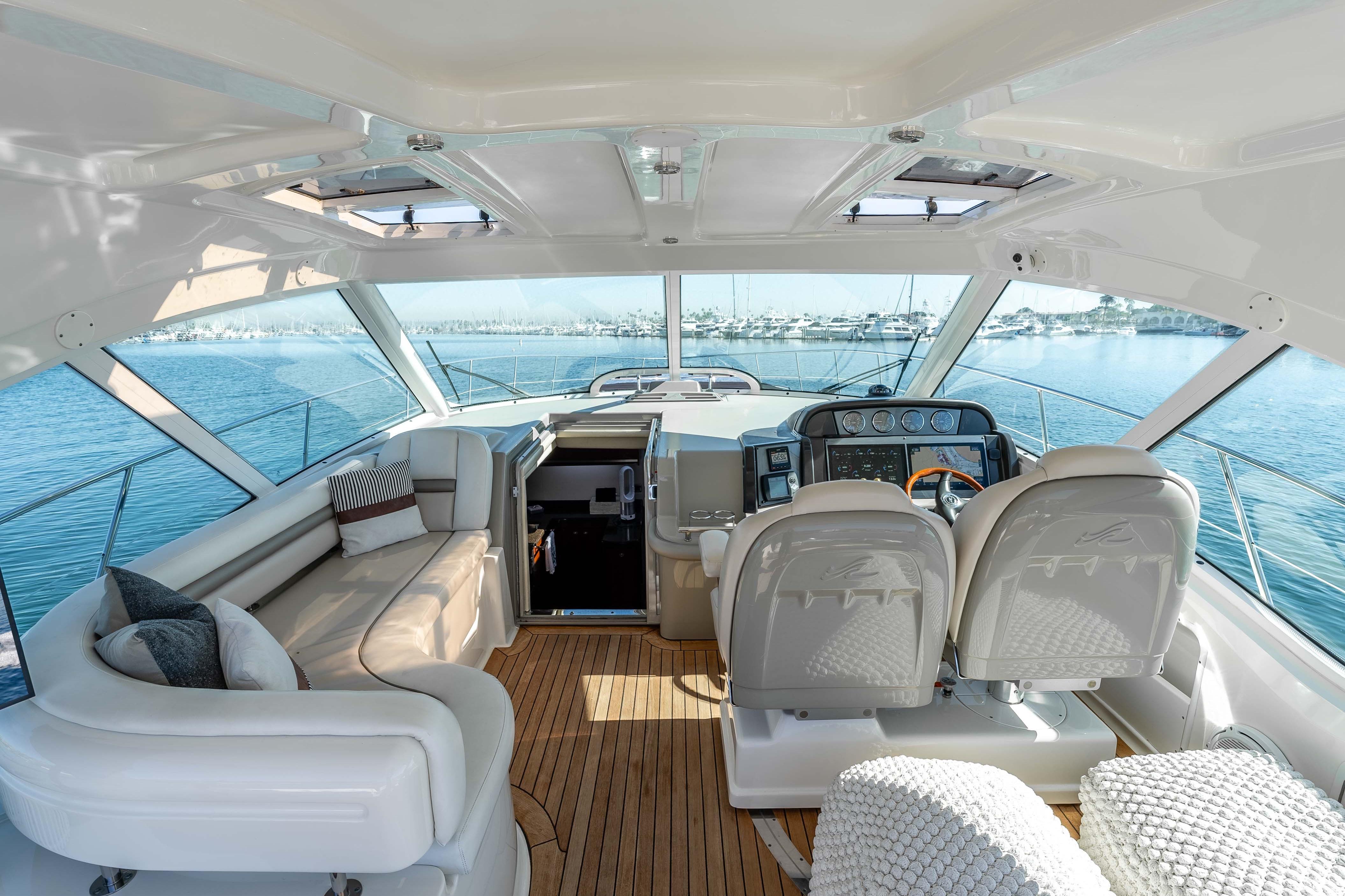Luxurious 2007 Sea Ray 48 Sundancer yacht interior with plush seating and modern helm.