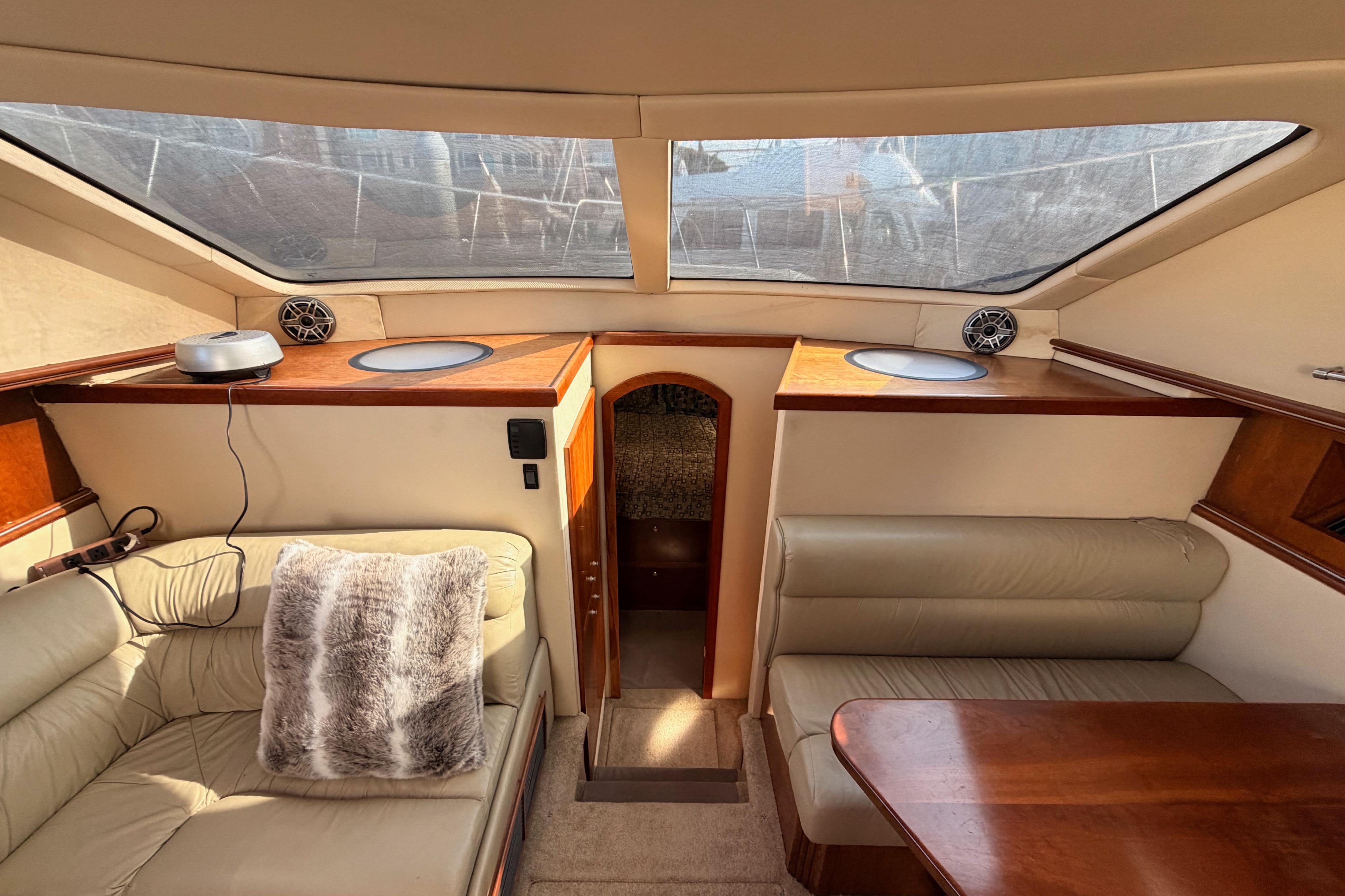 Luxurious interior of 2005 Cruisers Yachts 405 Express Motoryacht with plush seating and wood accents.