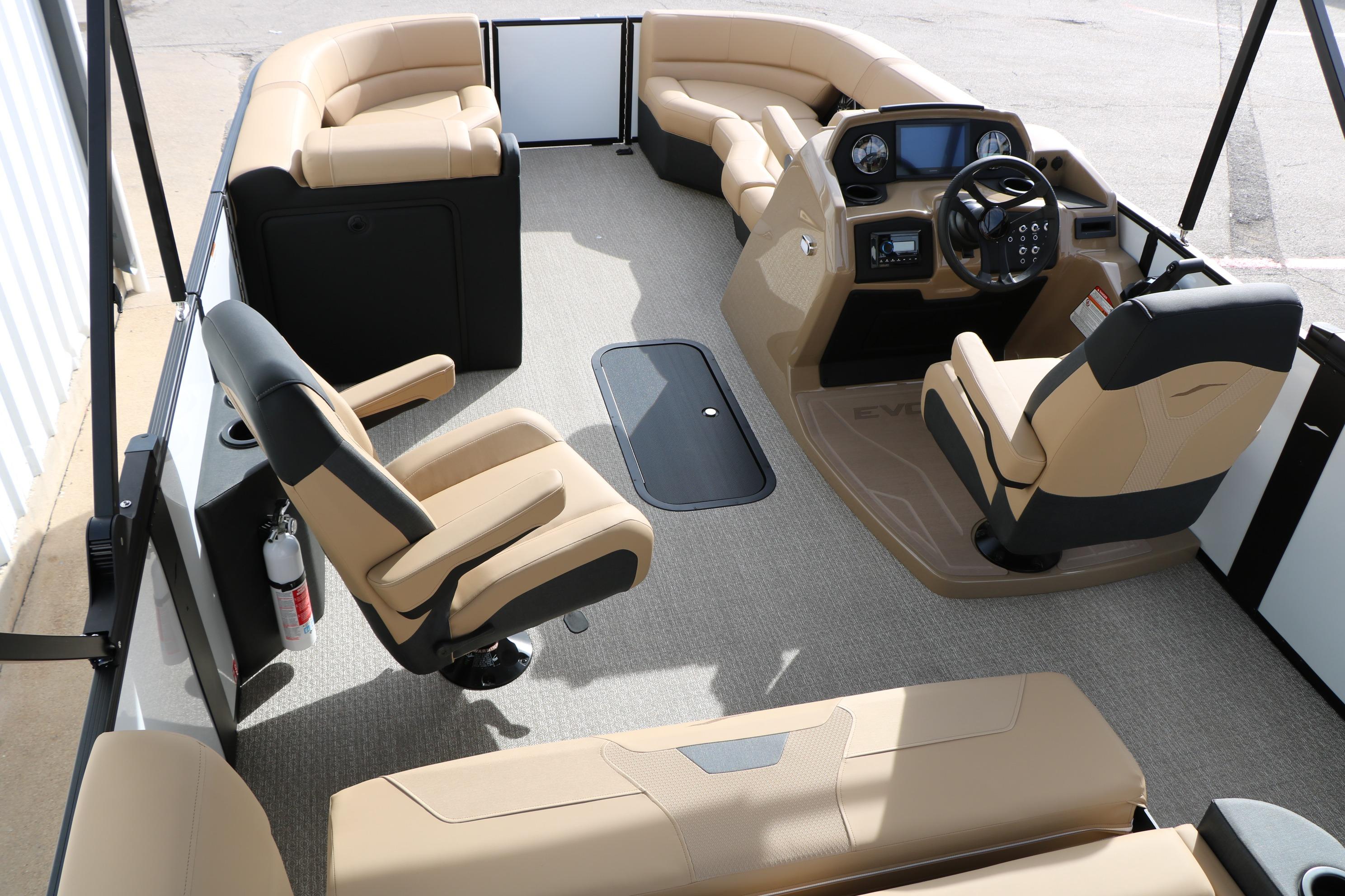 Luxurious interior of 2026 Evotti 523CS boat with beige seating and modern dashboard.